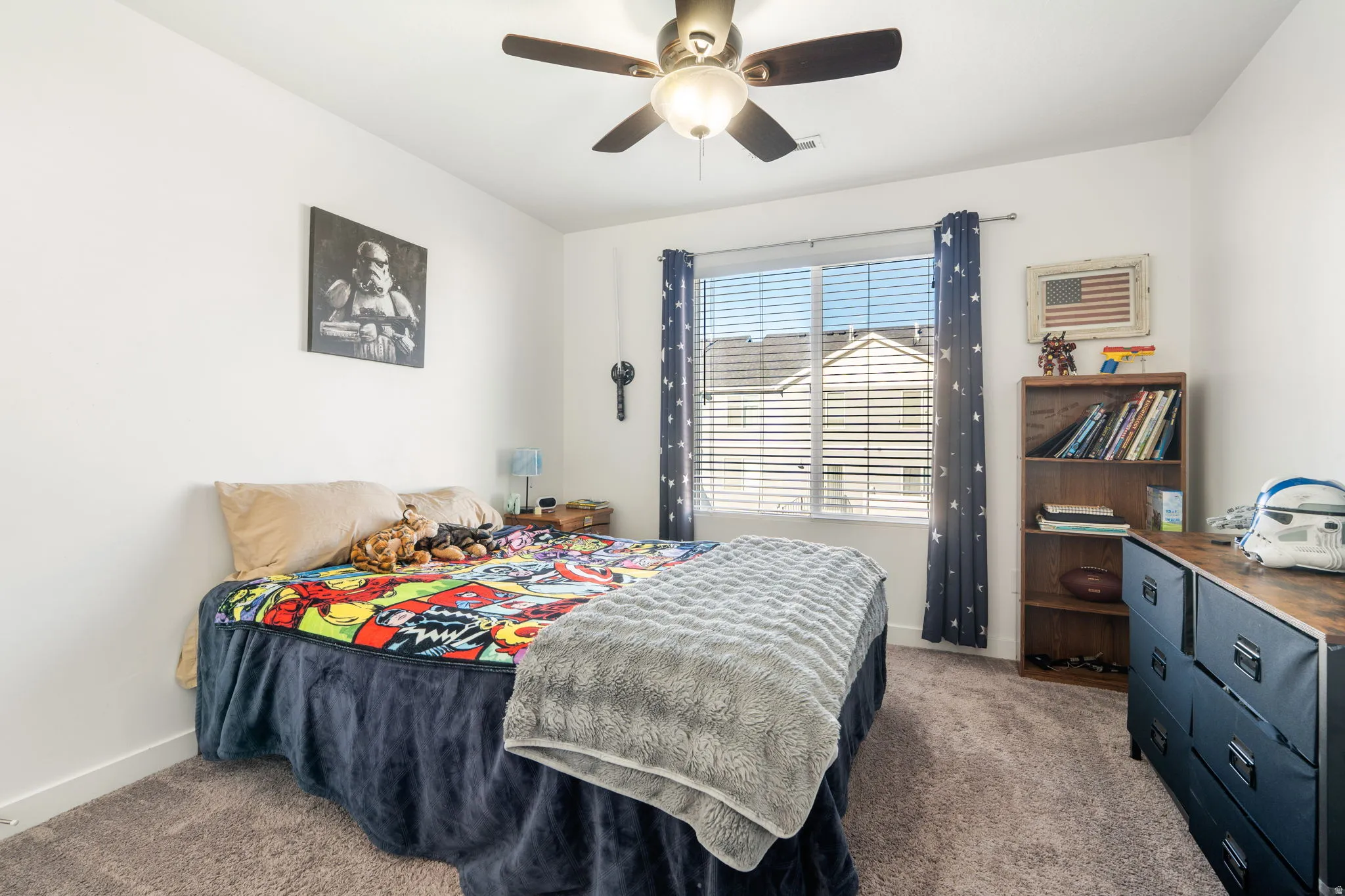 Bedroom with ceiling fan and carpet