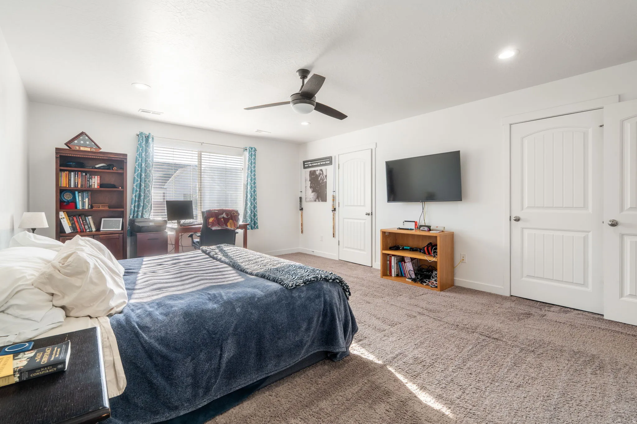 Carpeted bedroom with baseboards and ceiling fan