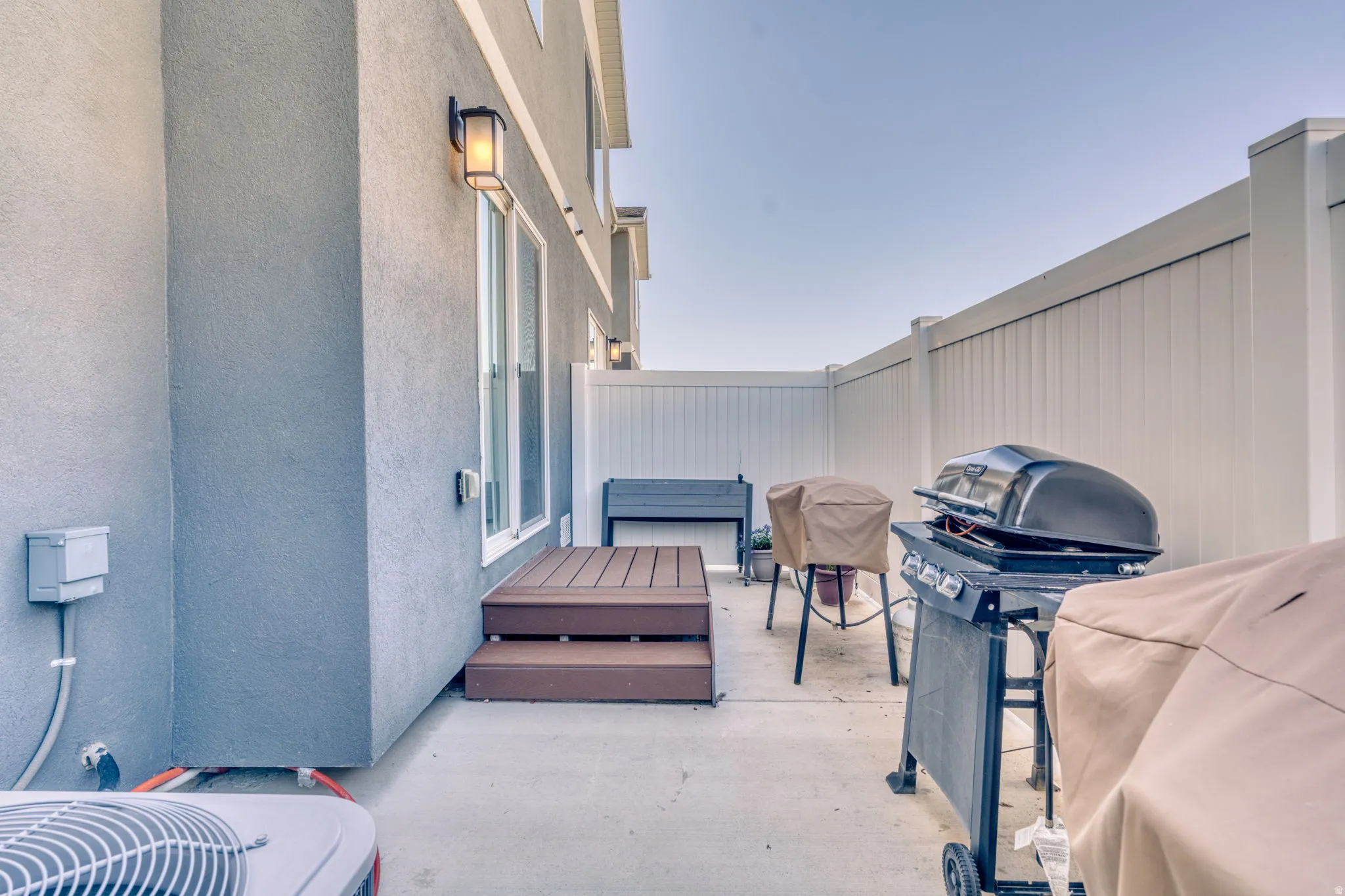 View of patio featuring grilling area and a deck