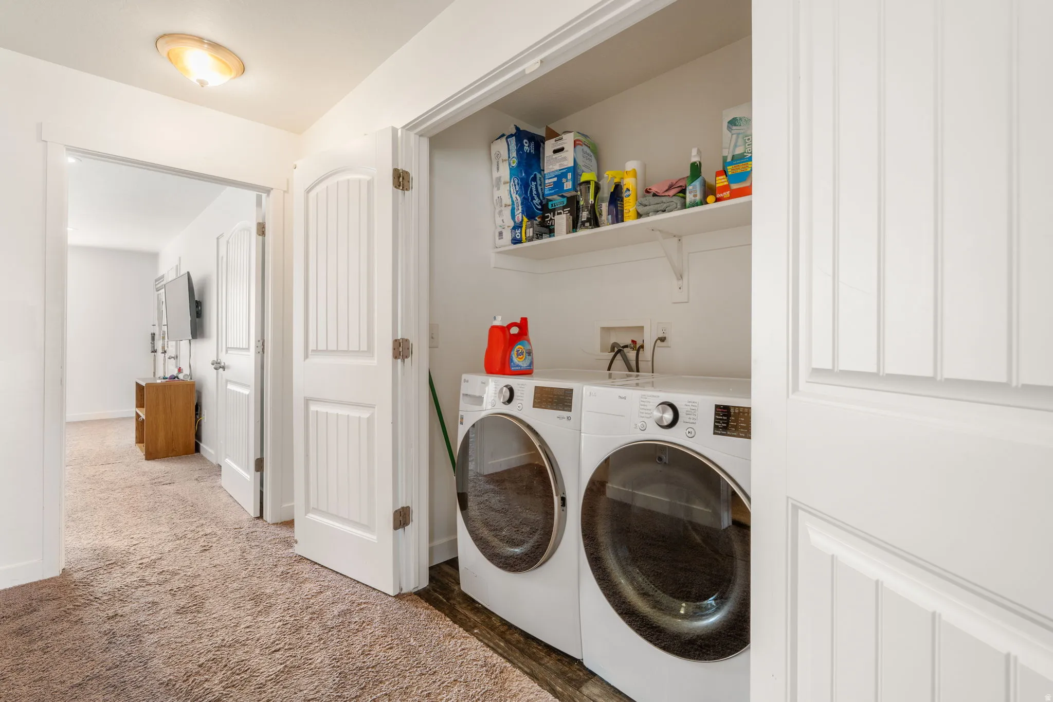 Laundry area with independent washer and dryer and carpet