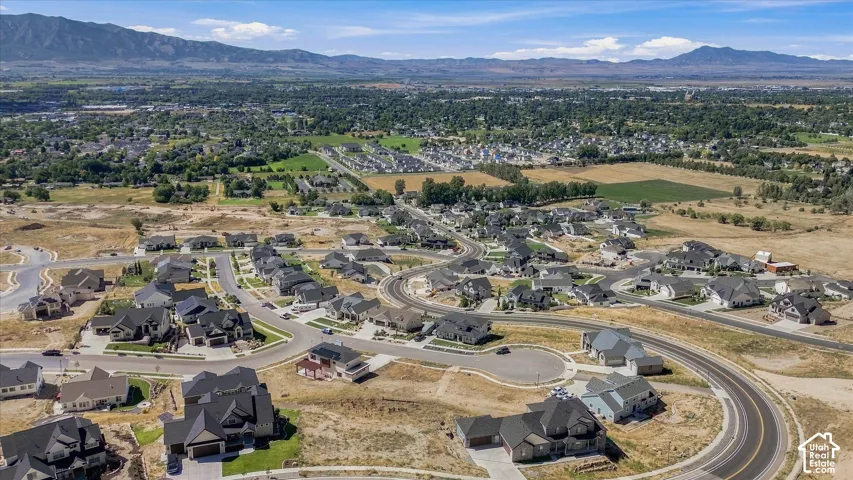 New construction residential development with paved roads and mountain backdrop