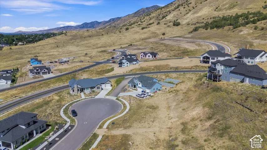 Expansive hillside development featuring multiple new construction homes, paved roadways, and cul-de-sacs