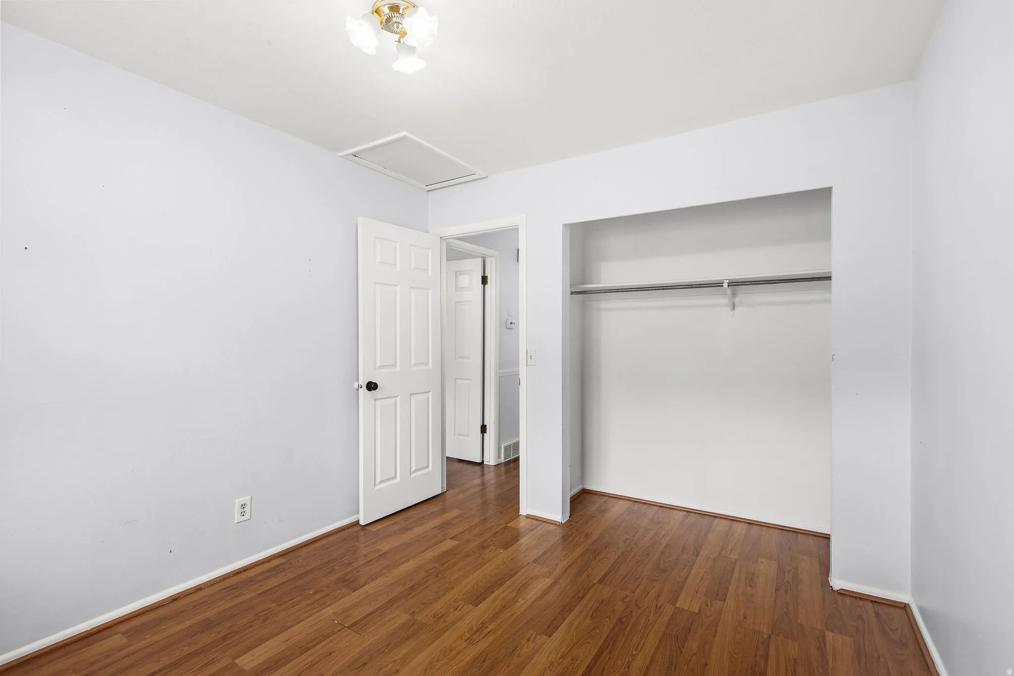 Interior room featuring wood-finish flooring and light-toned walls