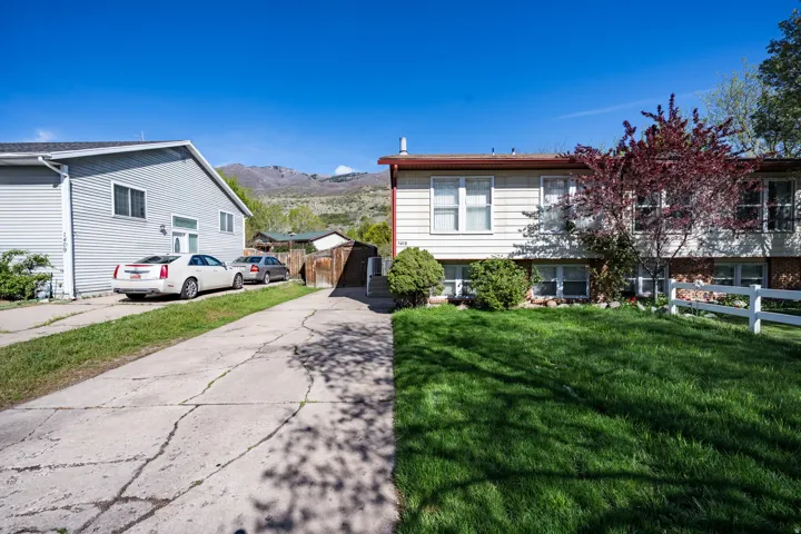 View of front facade featuring a mountain view and driveway