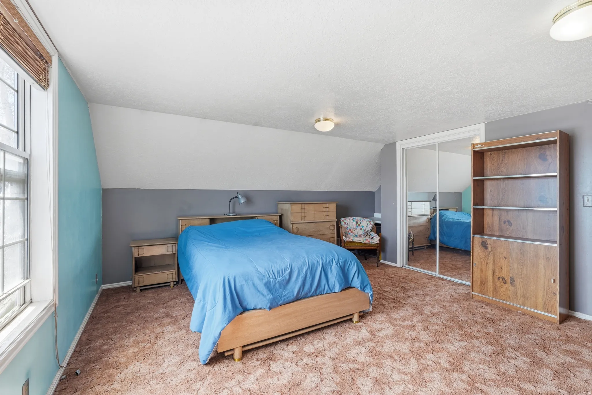 Carpeted bedroom featuring a closet and baseboards