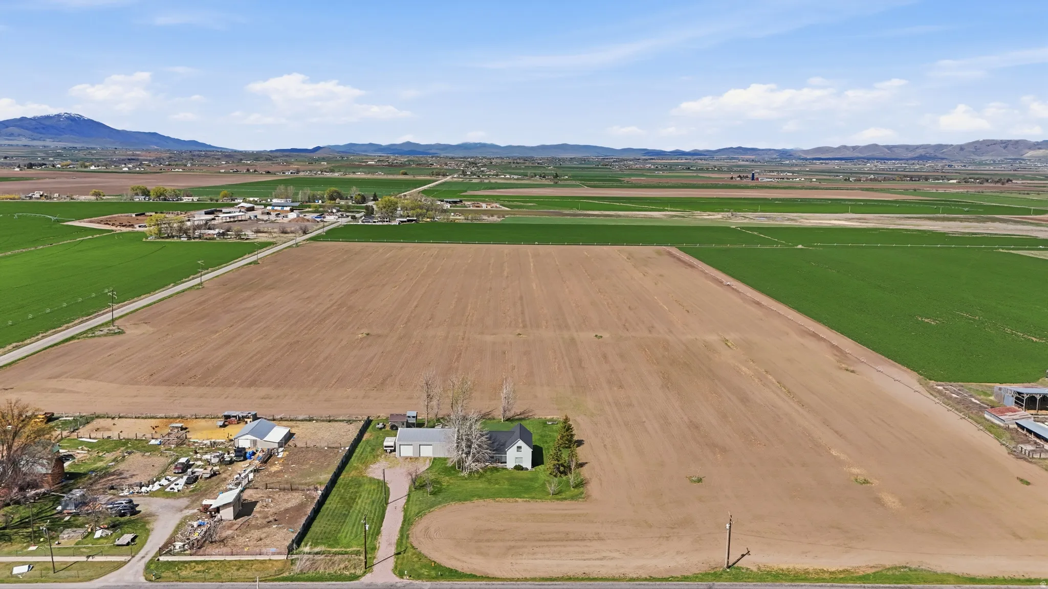 Aerial view of sparsely populated area featuring mountains and abundant farmland
