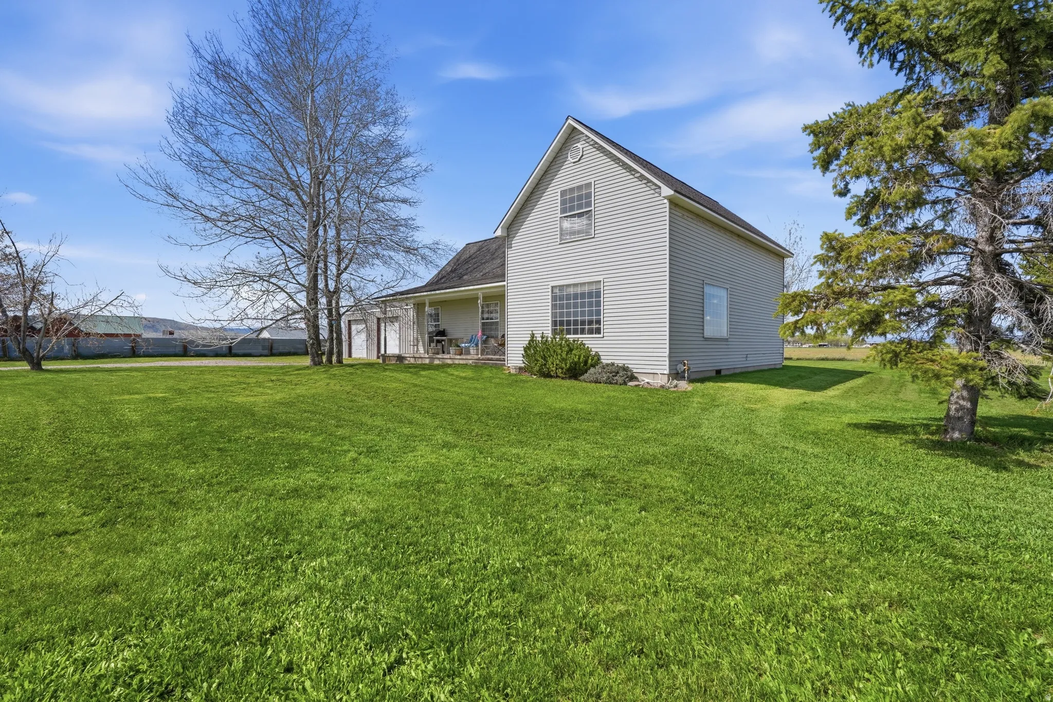 View of home's exterior with a lawn and a patio