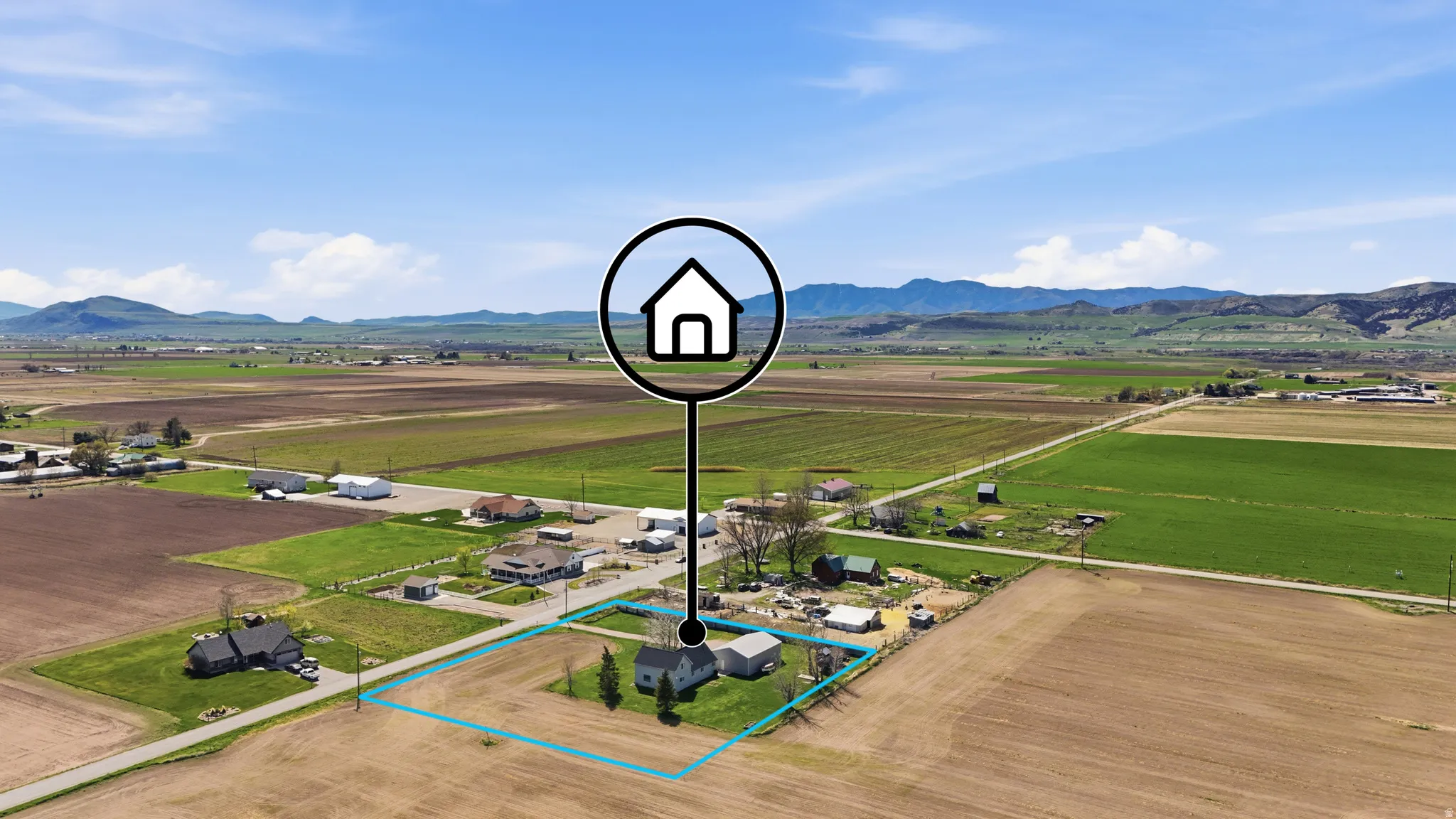 Overview of rural landscape with property boundaries highlighted and a mountainous background