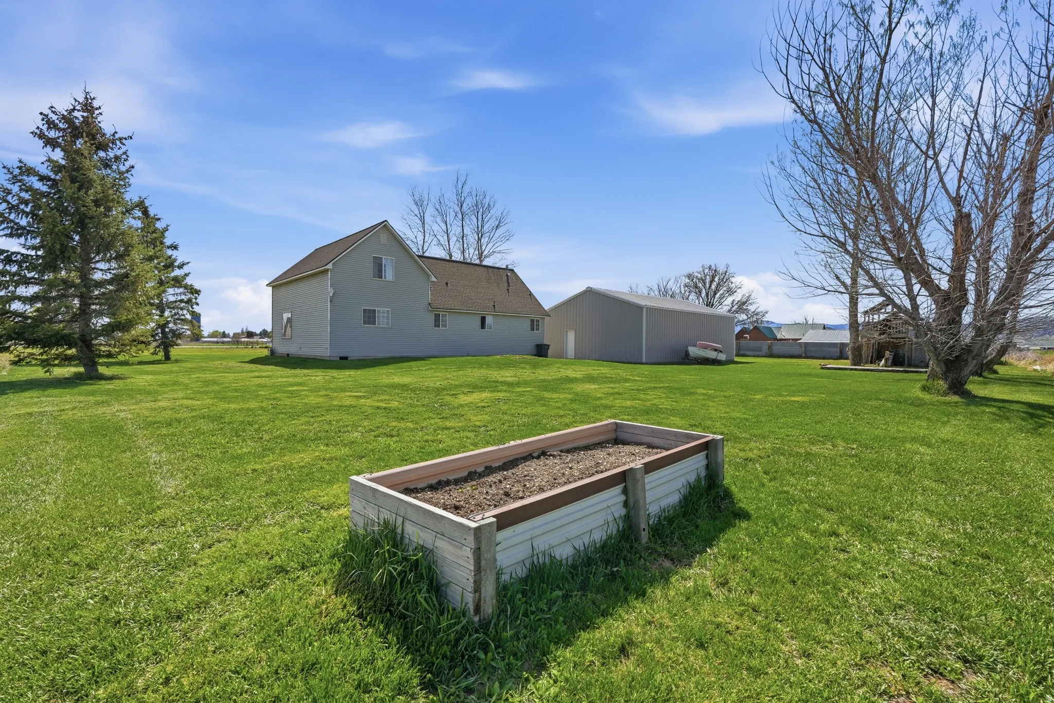 View of green lawn featuring a garden