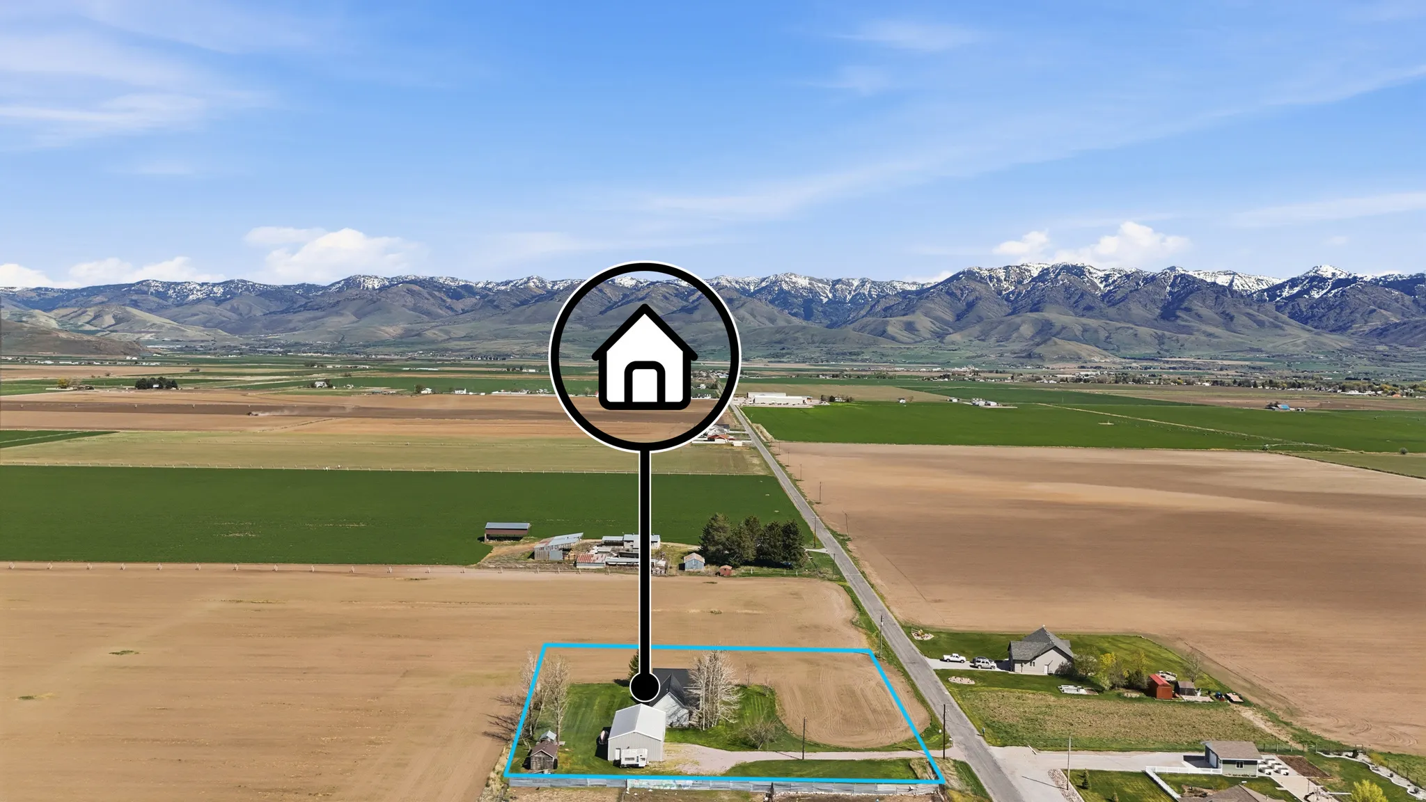 View of mountain backdrop with rural landscape