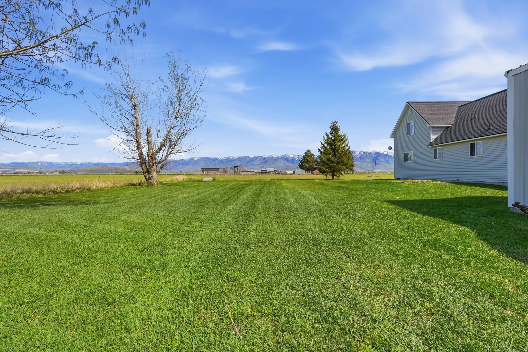 View of grassy yard featuring a mountain view and a rural view