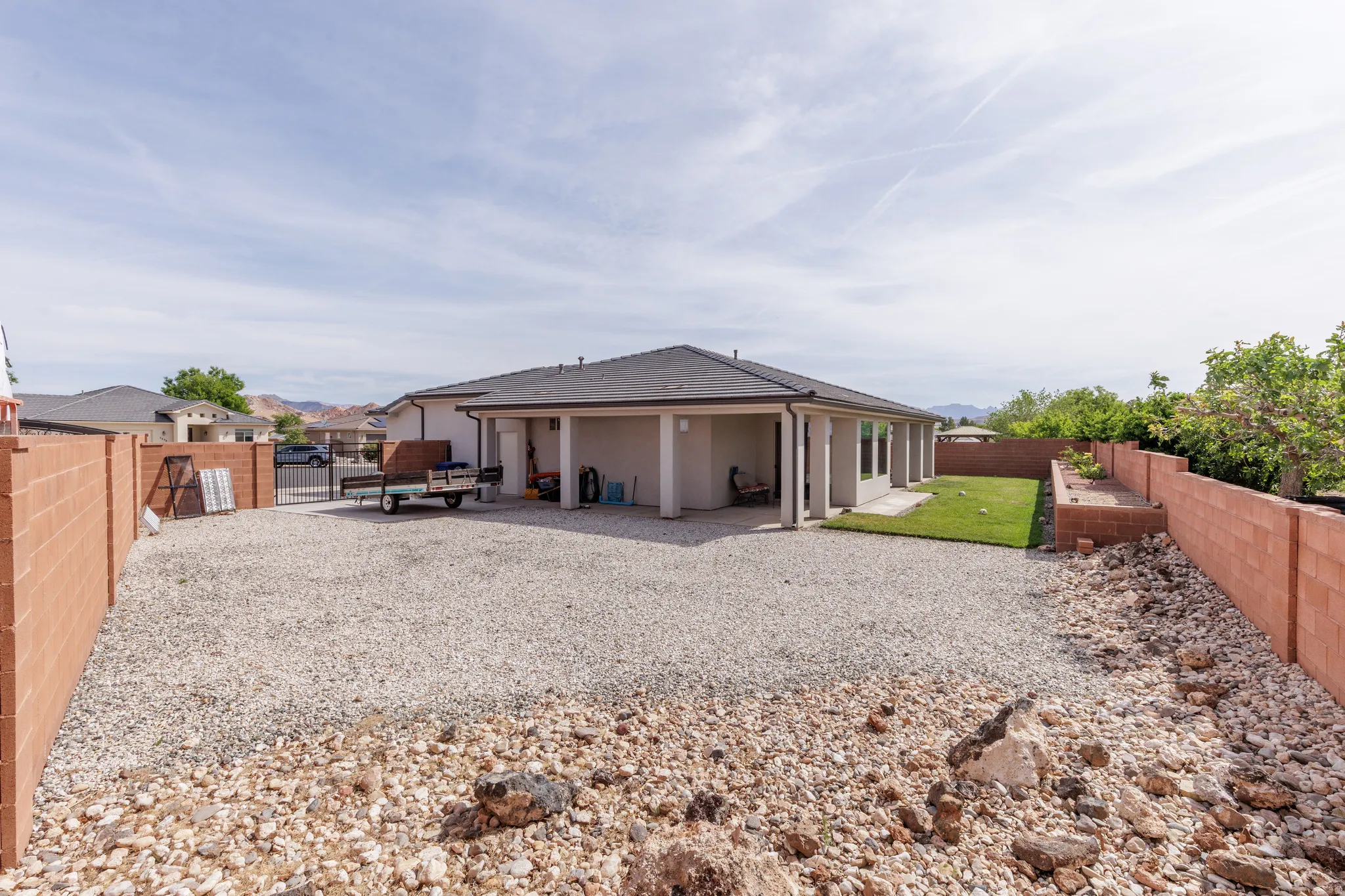 Back of property featuring a patio, a fenced backyard, and stucco siding