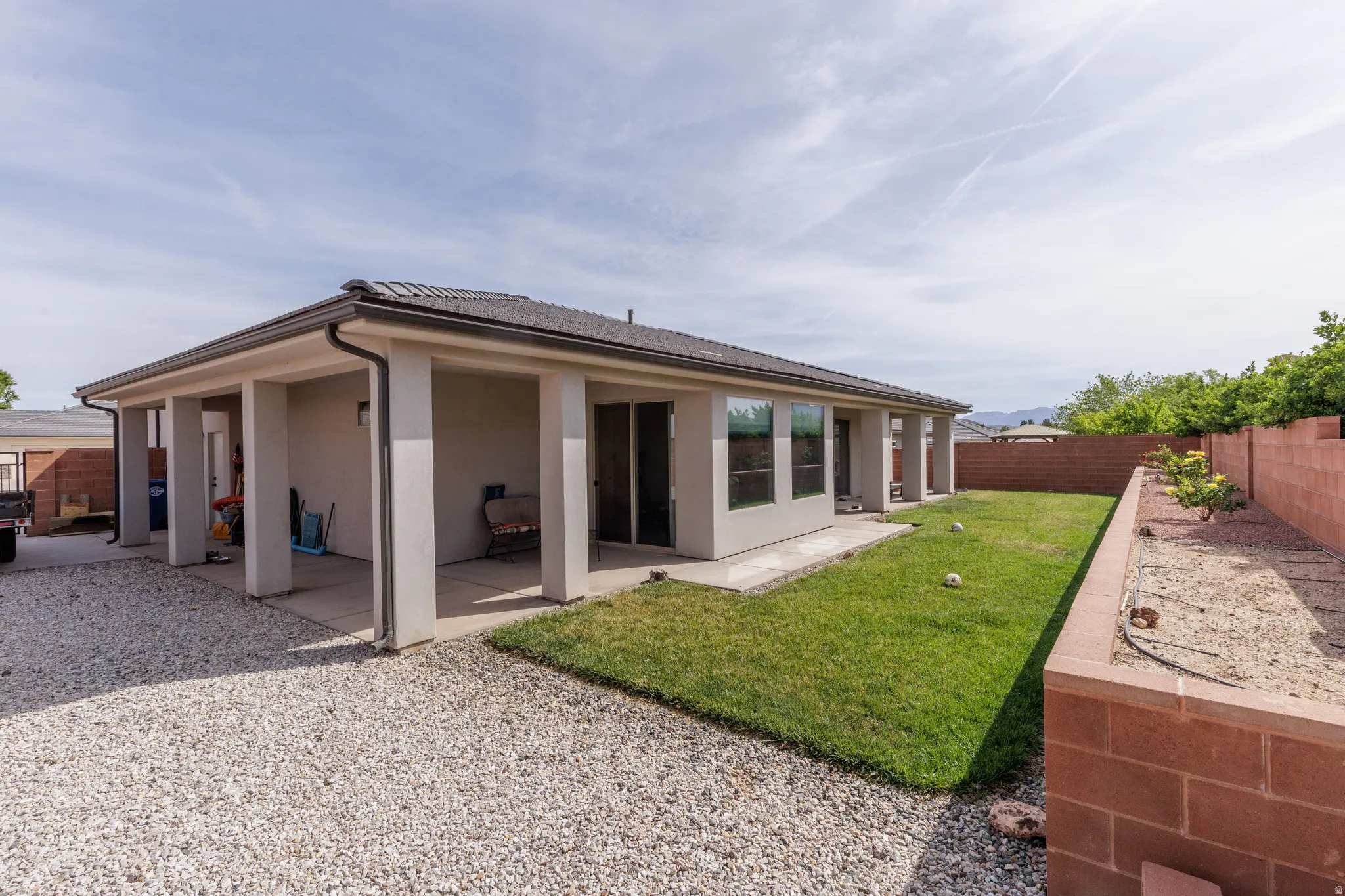 Rear view of property with a patio, a fenced backyard, and stucco siding