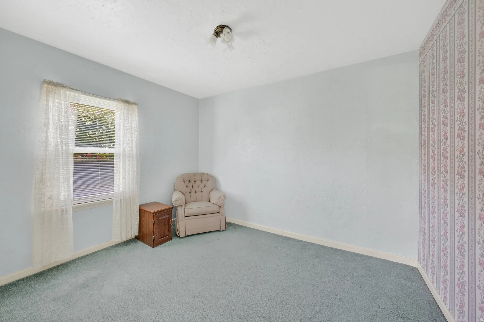 Unfurnished room with light colored carpet and baseboards