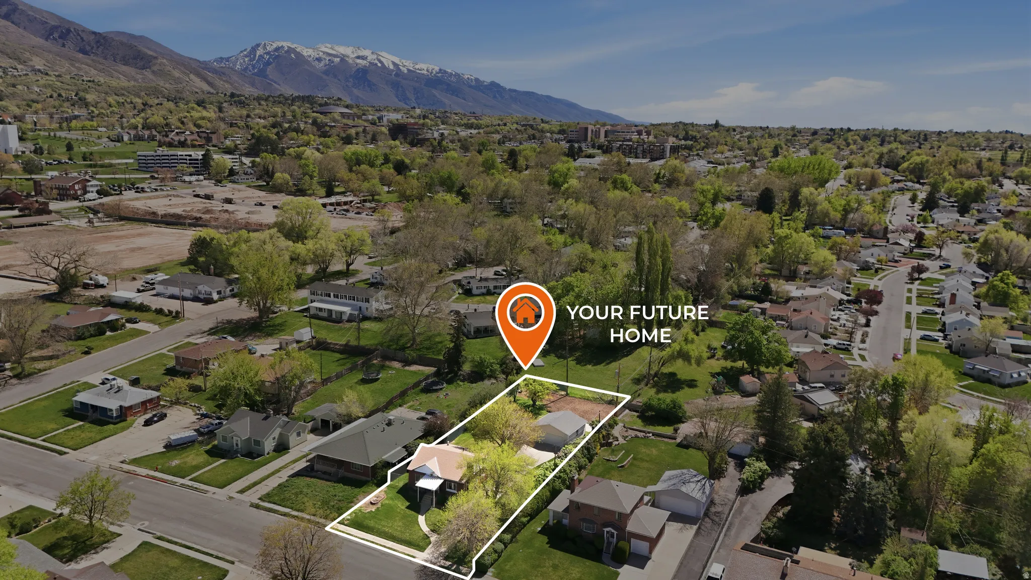 Aerial perspective of suburban area featuring property boundaries highlighted and mountains