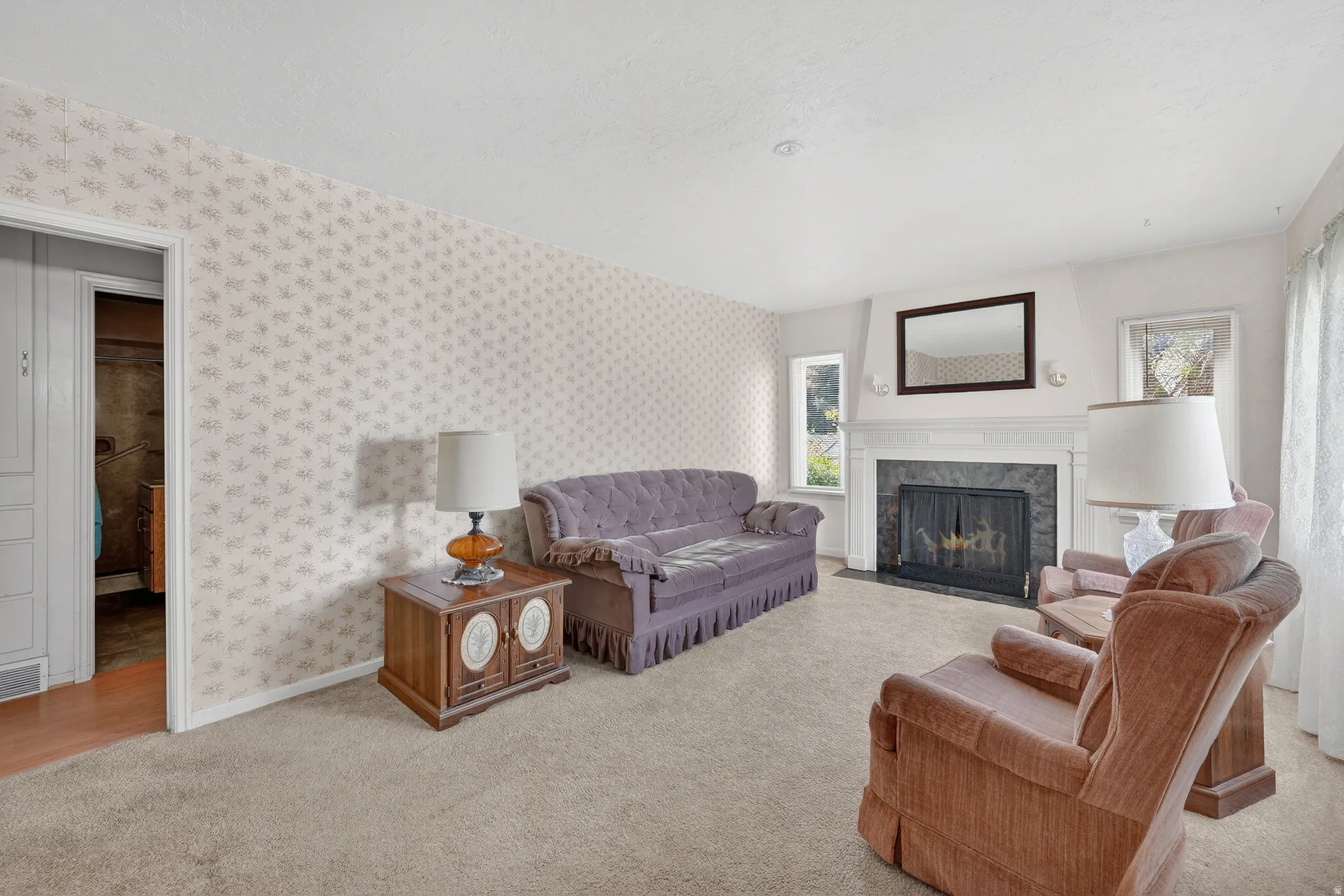 Living room featuring light carpet and a premium fireplace