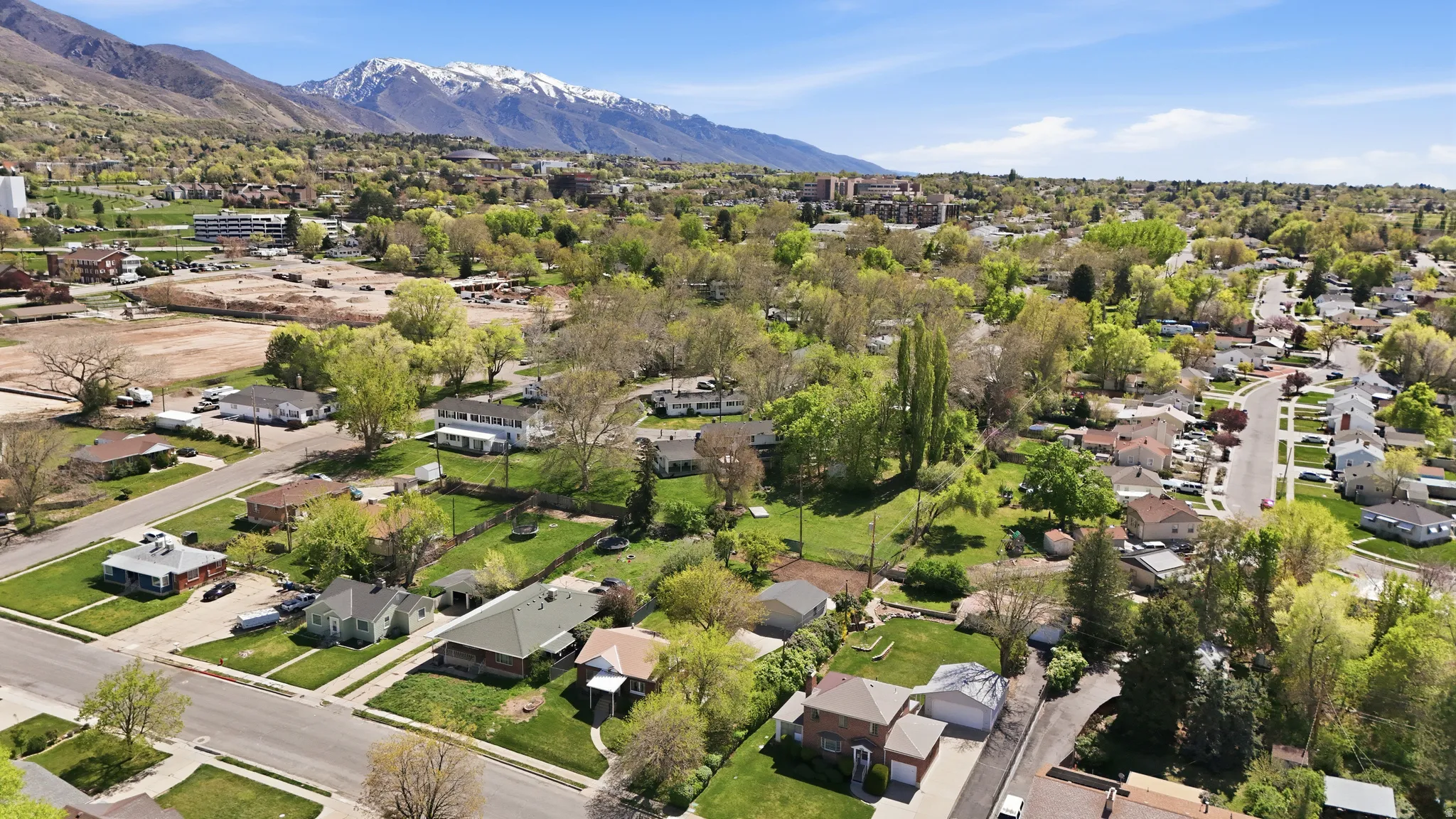 Aerial perspective of suburban area with a mountainous background