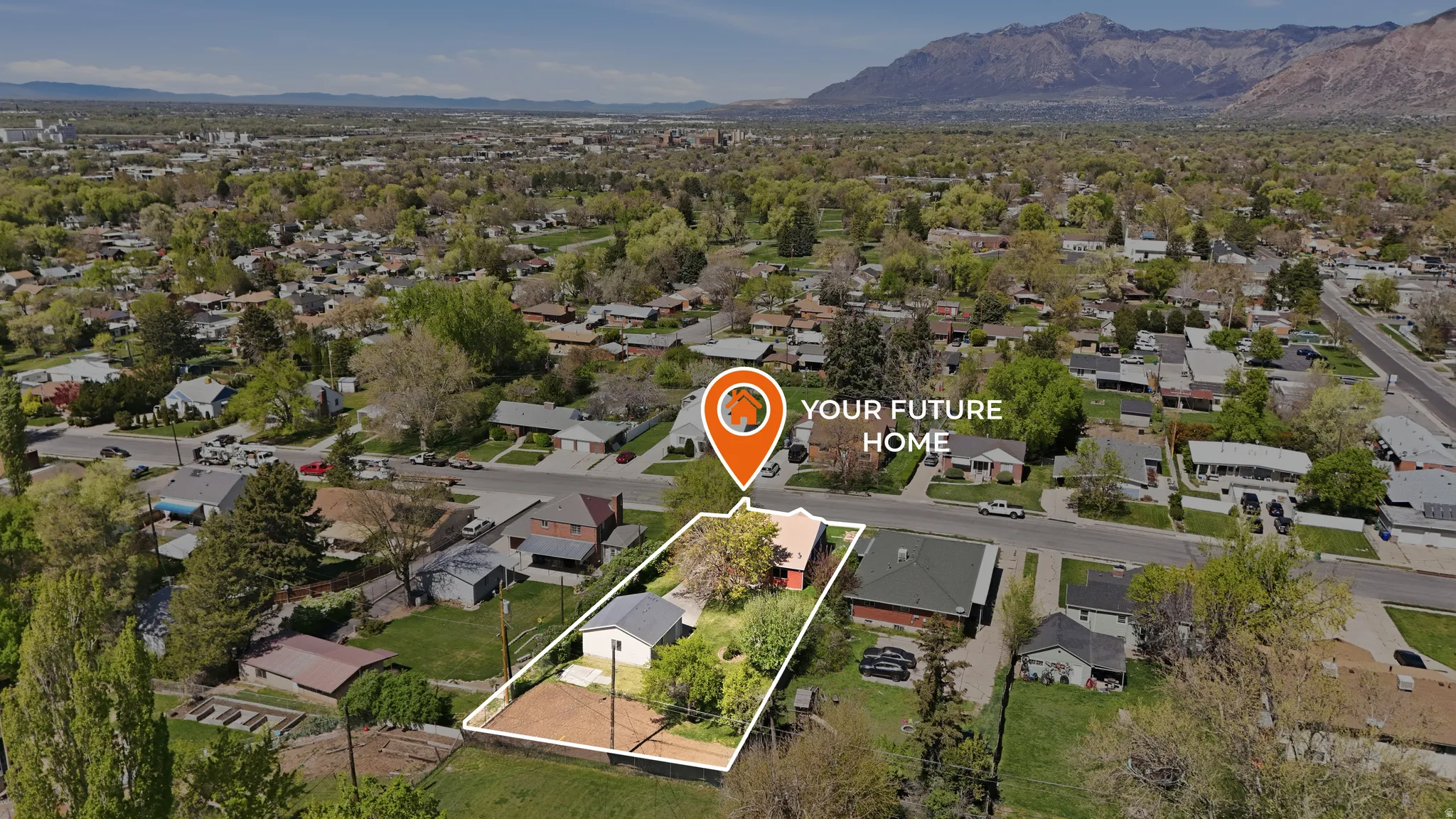 Aerial perspective of suburban area featuring property parcel outlined and mountains