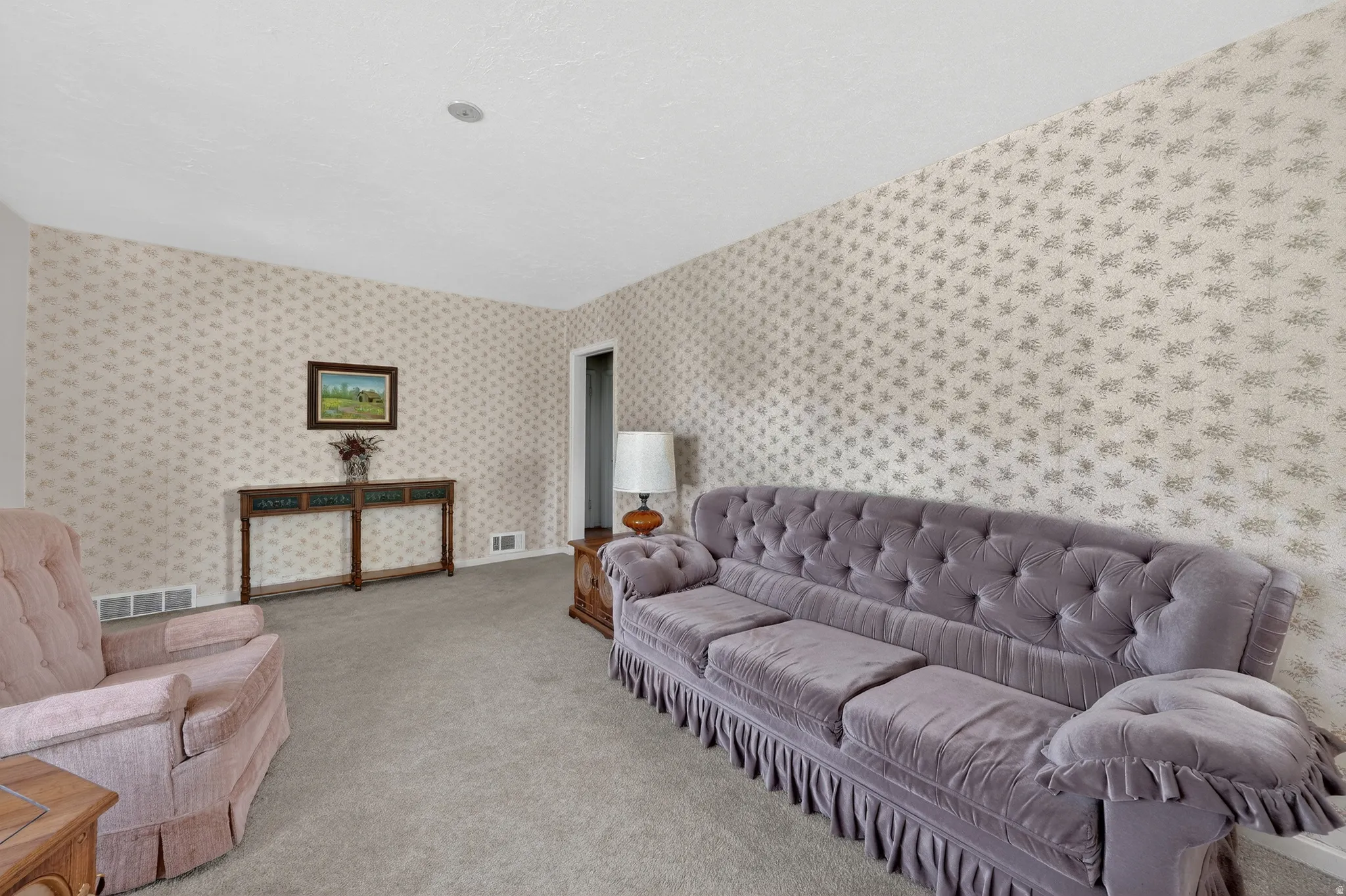 Living area featuring light carpet