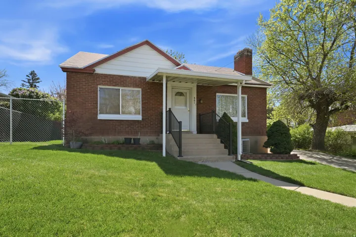 Bungalow-style house with brick siding and a chimney
