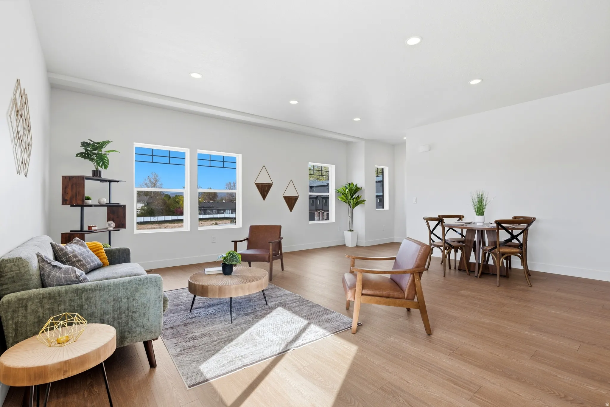 Living area featuring light wood-style floors and recessed lighting