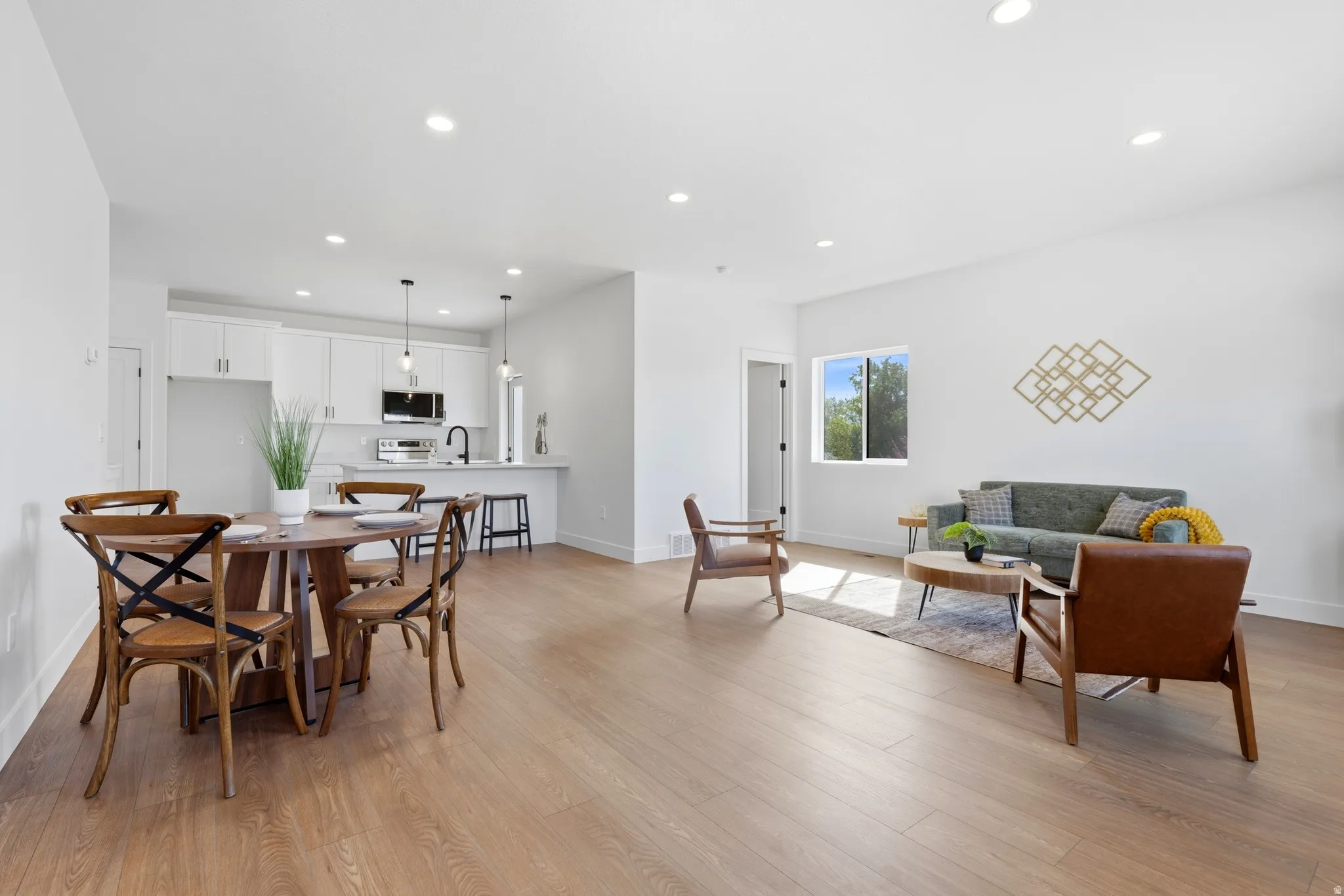 Dining area with recessed lighting and light wood finished floors