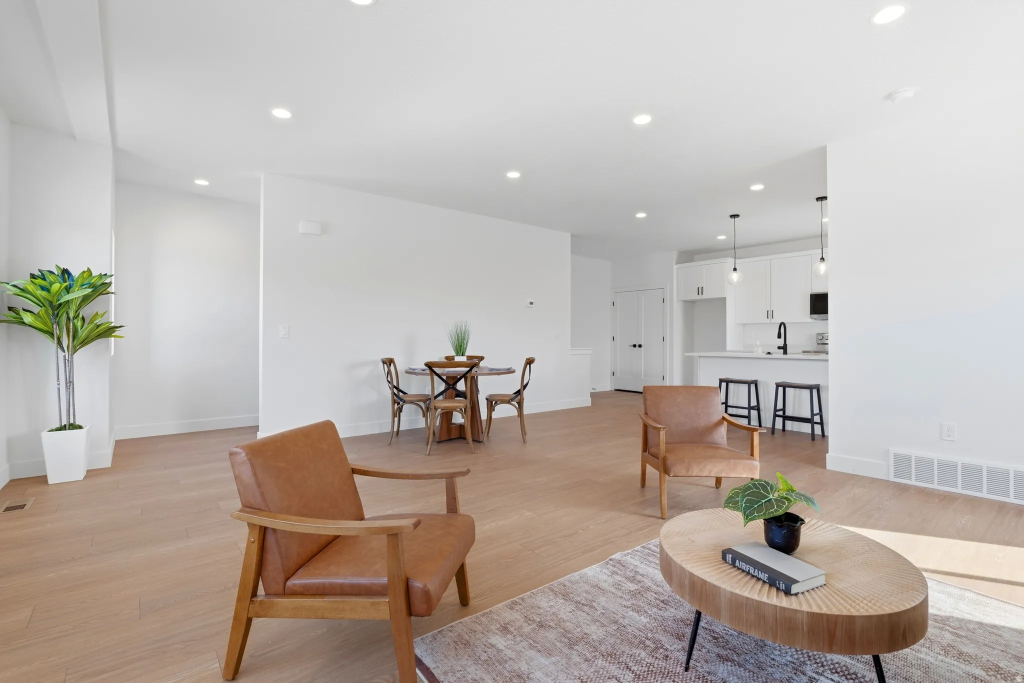 Living room featuring light wood-type flooring and recessed lighting
