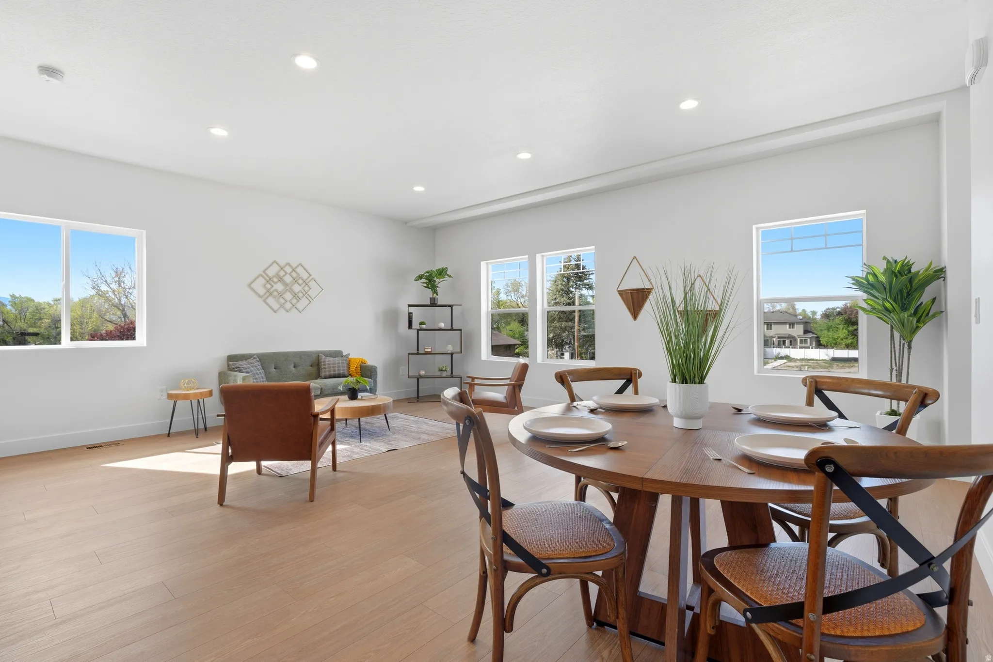 Dining space with light wood-style floors and recessed lighting