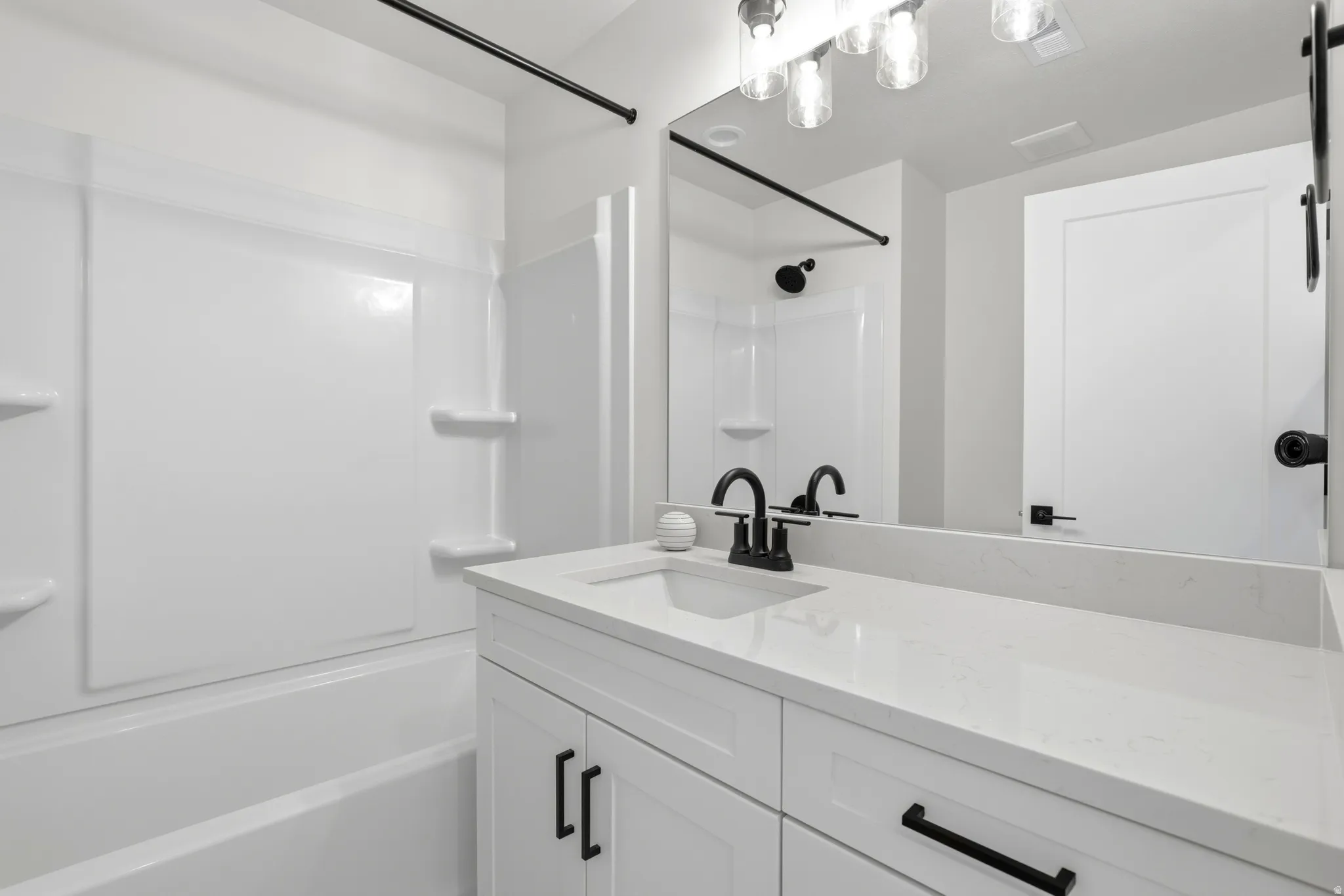 Bathroom featuring vanity and tub / shower combination