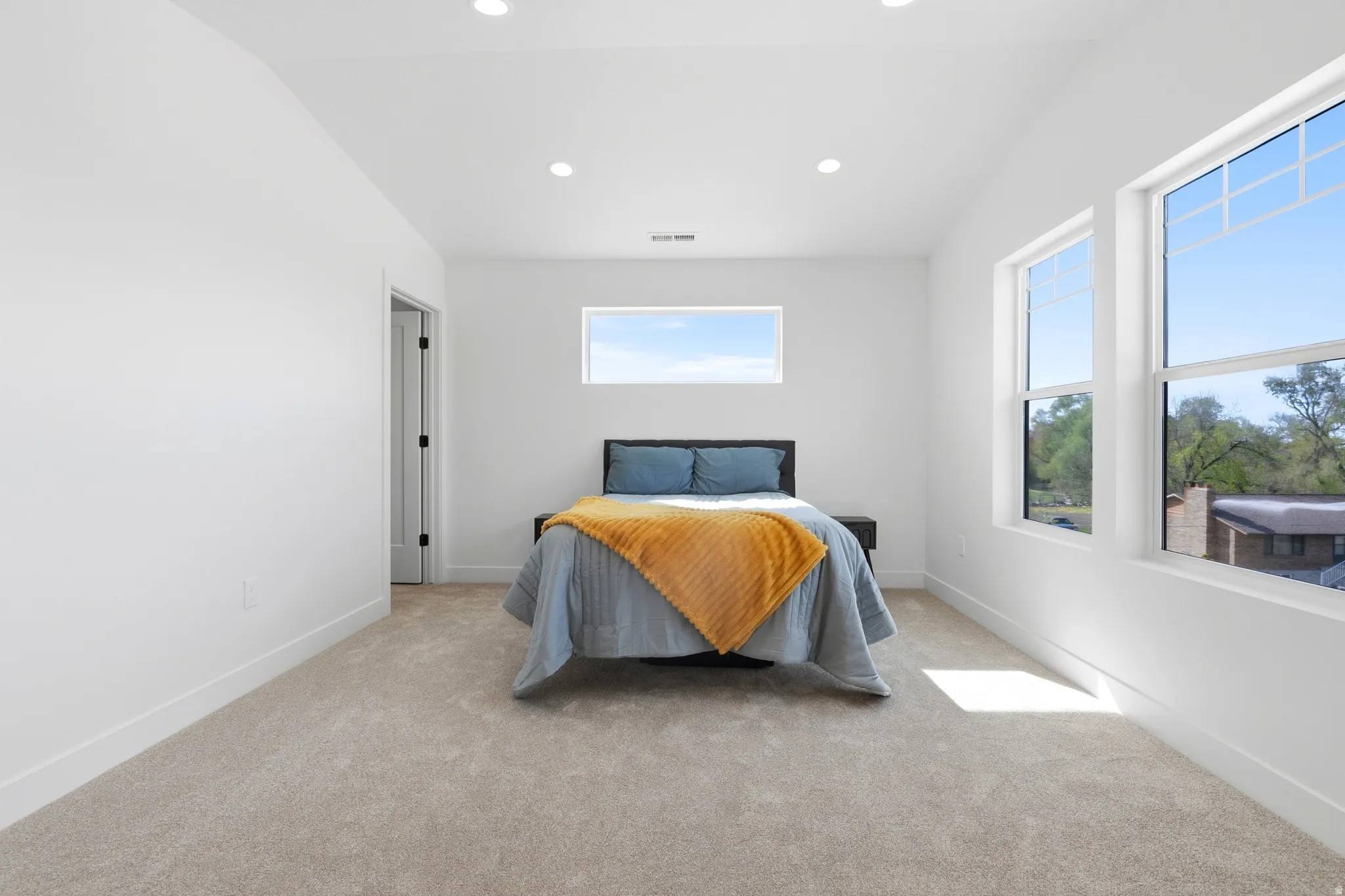 Bedroom with light carpet, recessed lighting, and lofted ceiling