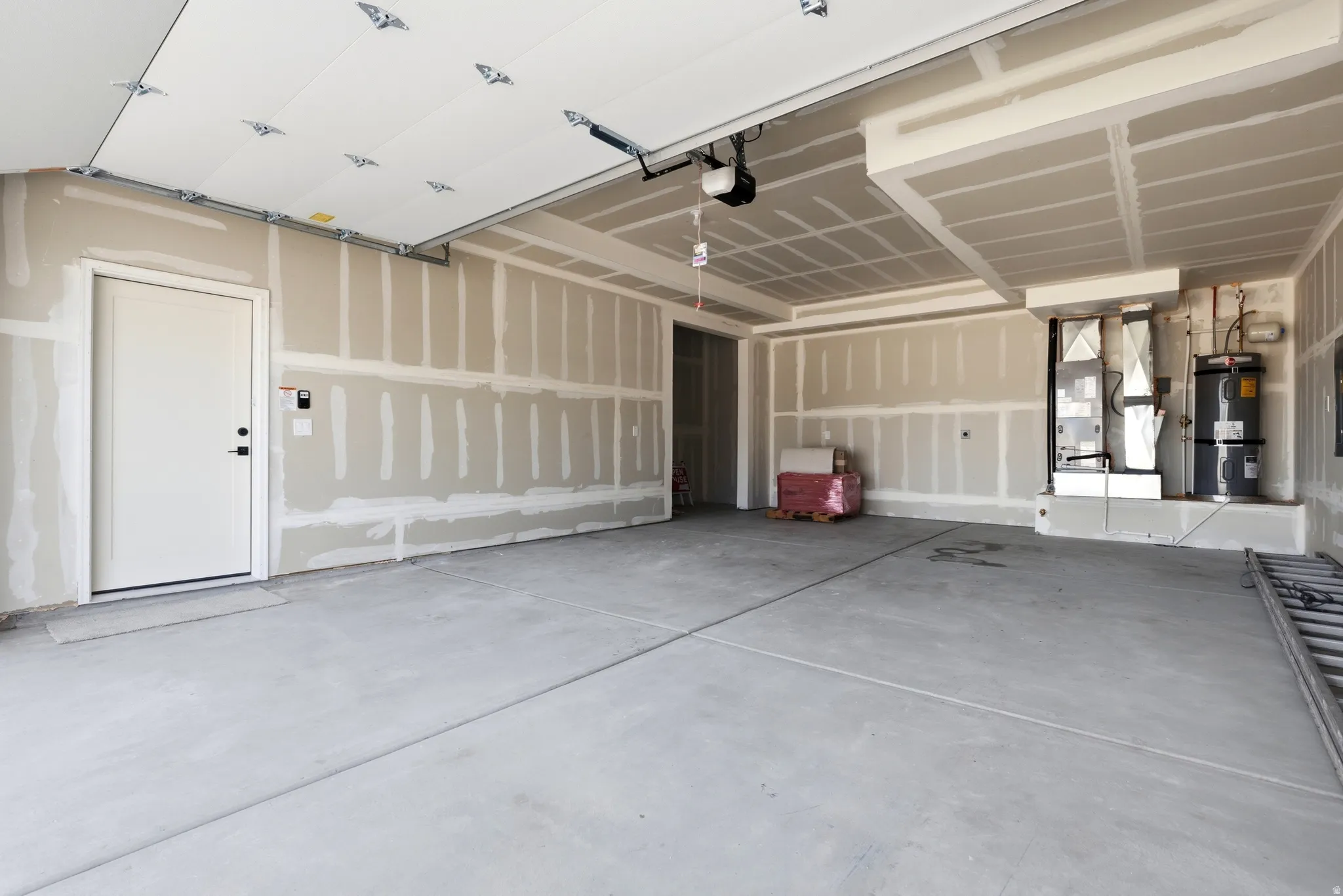 Garage with strapped water heater and heating unit