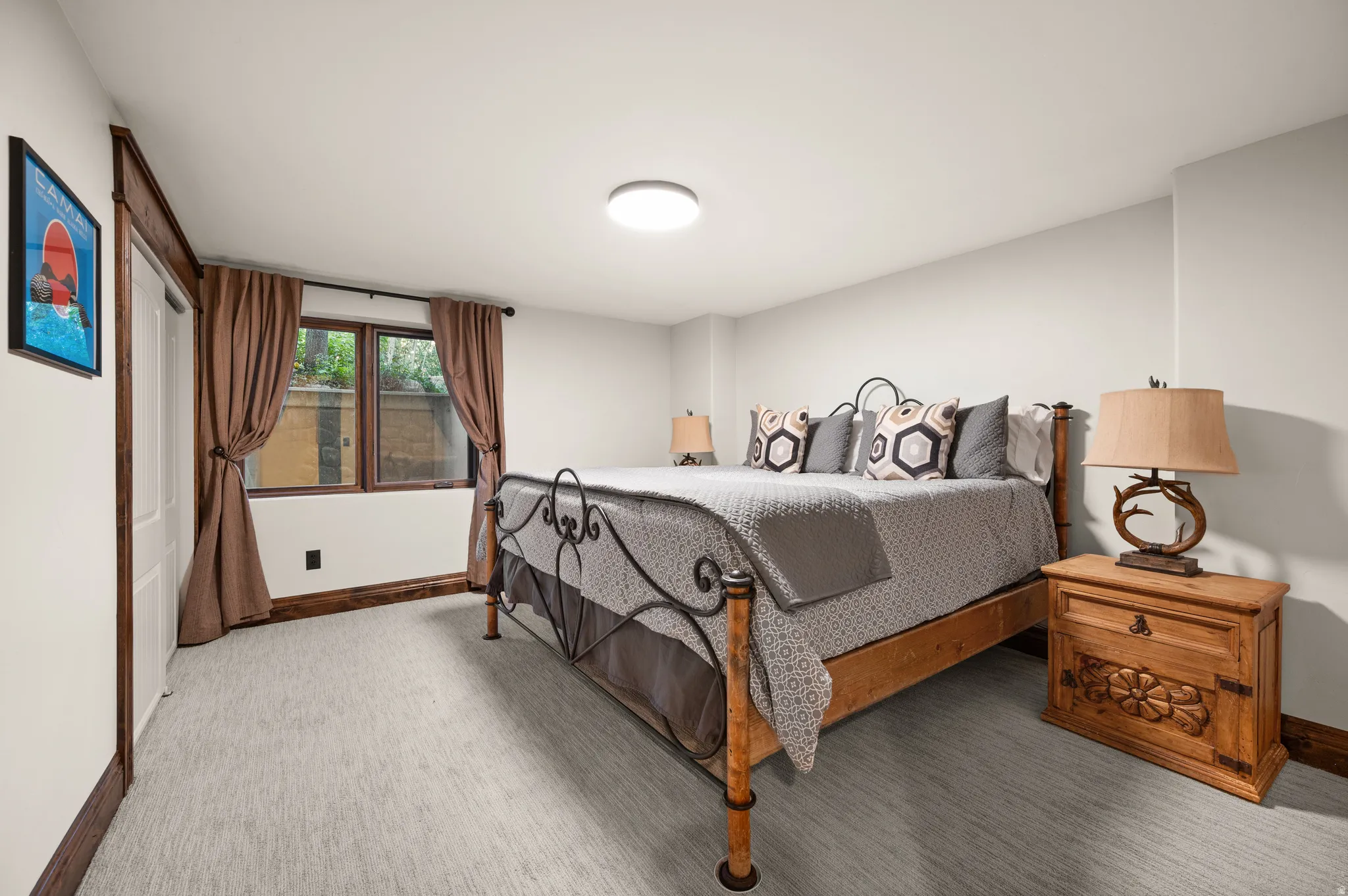 Bedroom with baseboards and light carpet