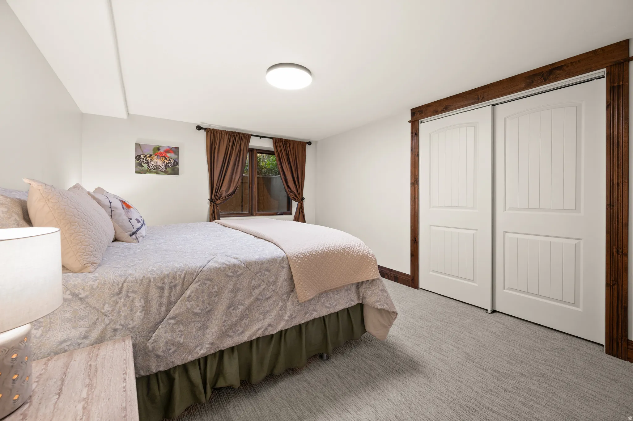 Bedroom featuring light colored carpet and a closet