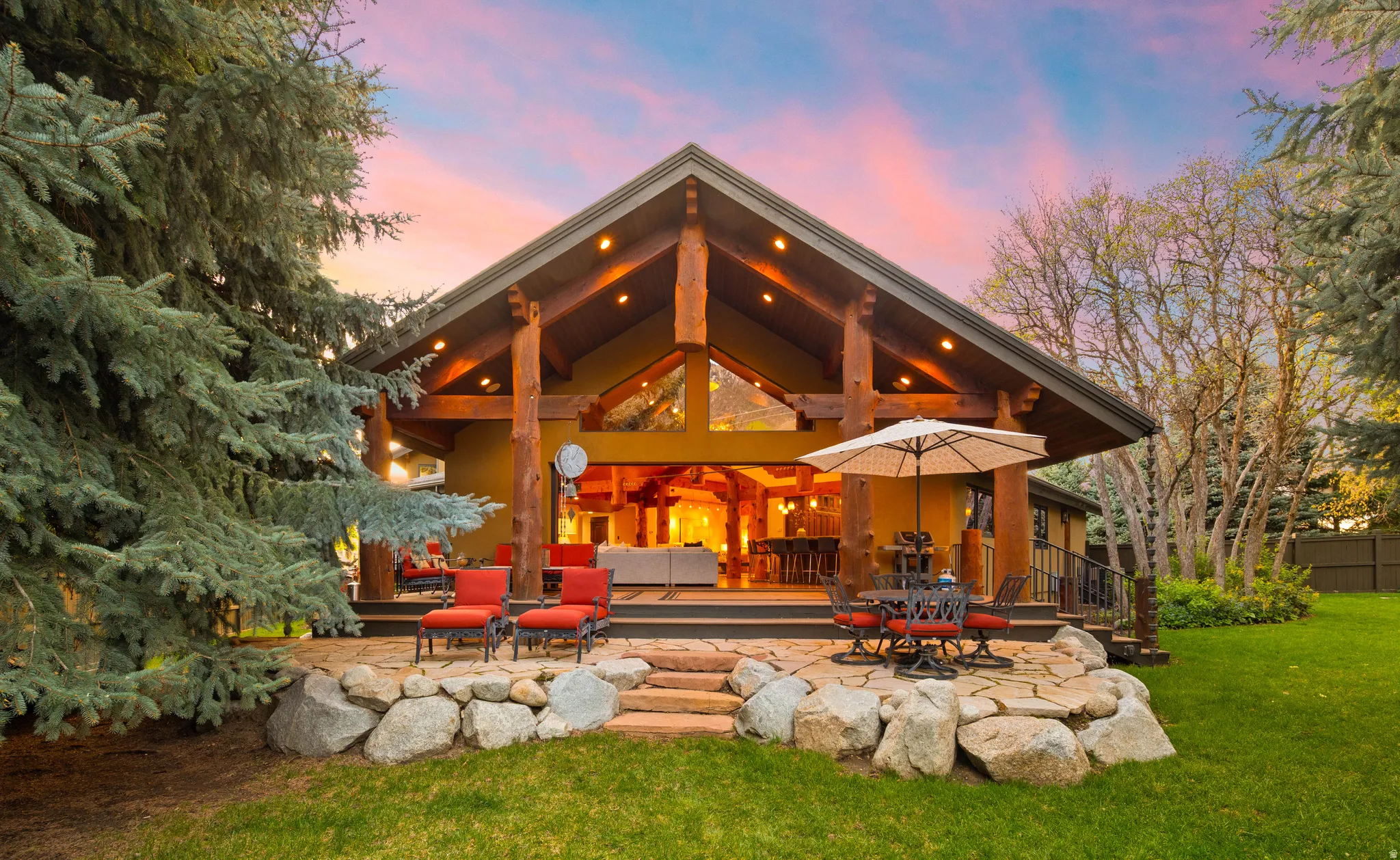 Back of property featuring an outdoor living / dining area and a patio