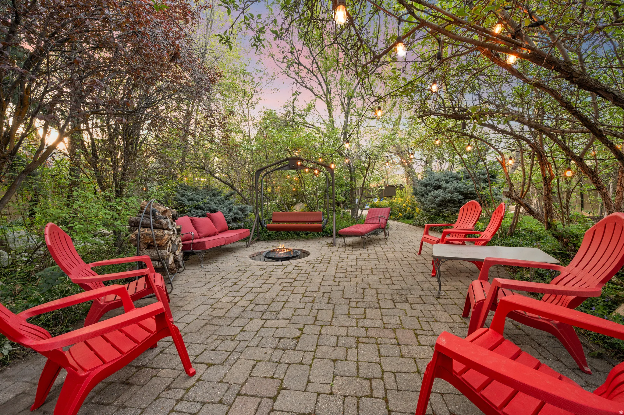 Patio terrace at dusk featuring an outdoor fire pit and a patio area