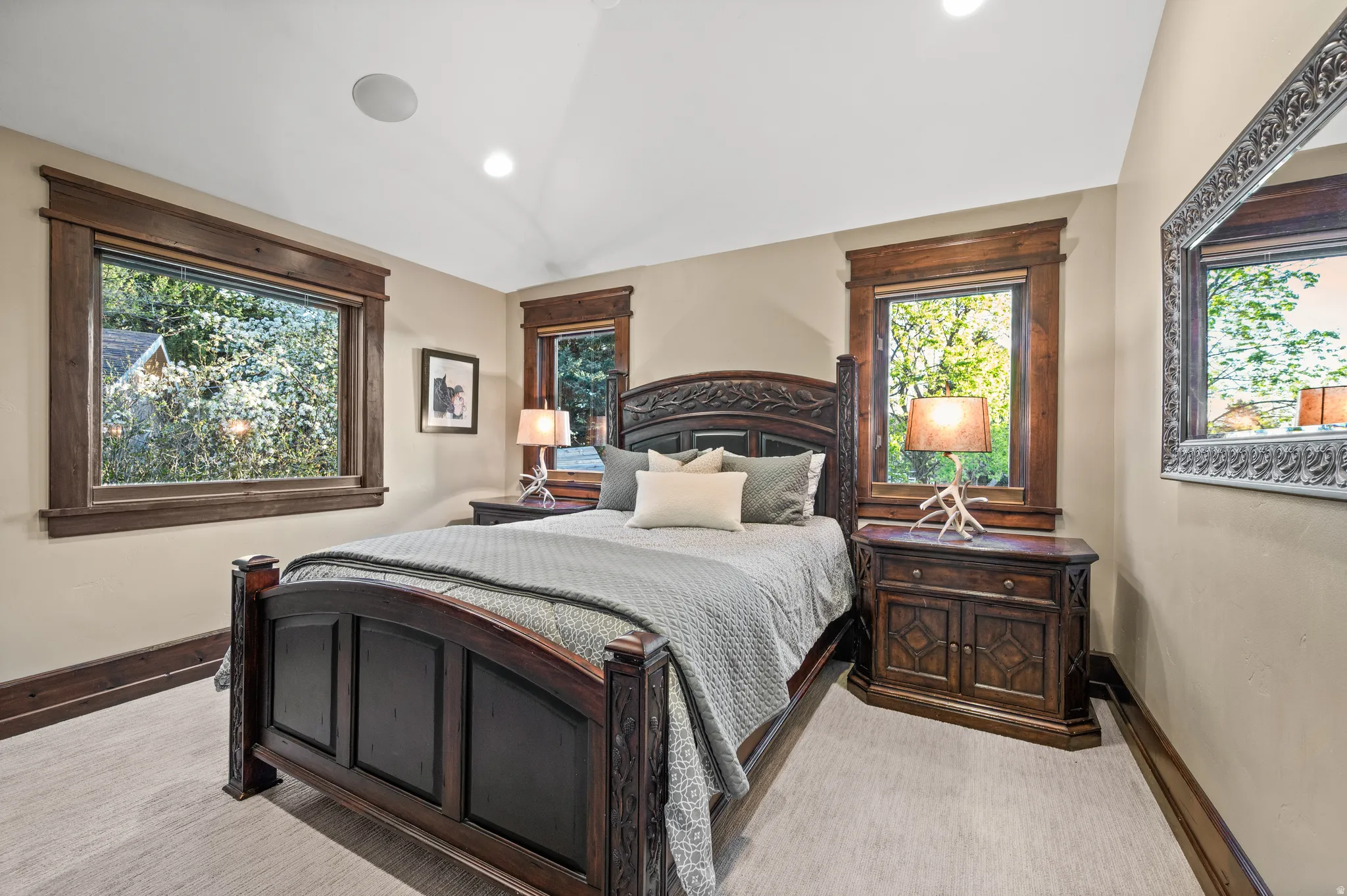 Bedroom featuring vaulted ceiling, light carpet, and recessed lighting