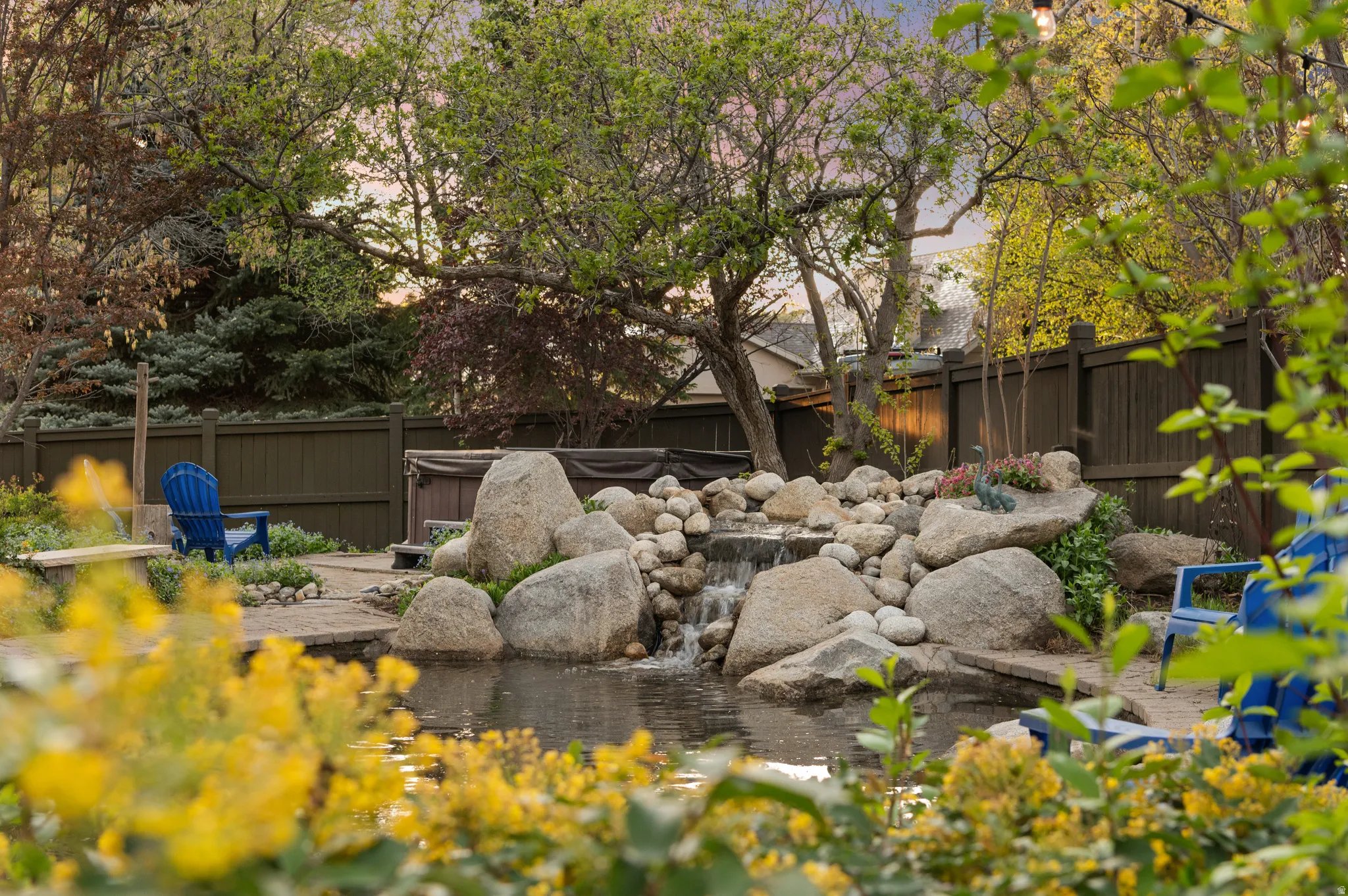 Fenced backyard with a small pond