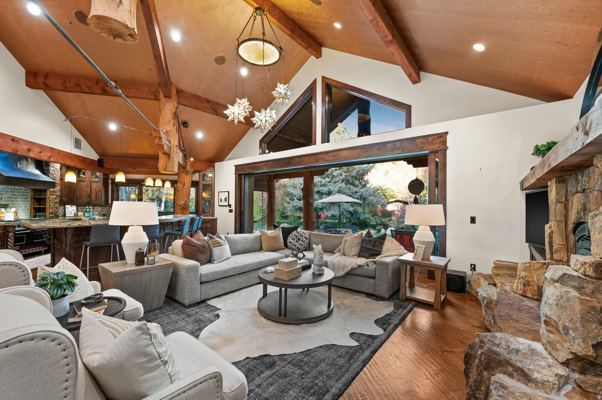 Living area featuring recessed lighting, wood finished floors, a stone fireplace, and french doors