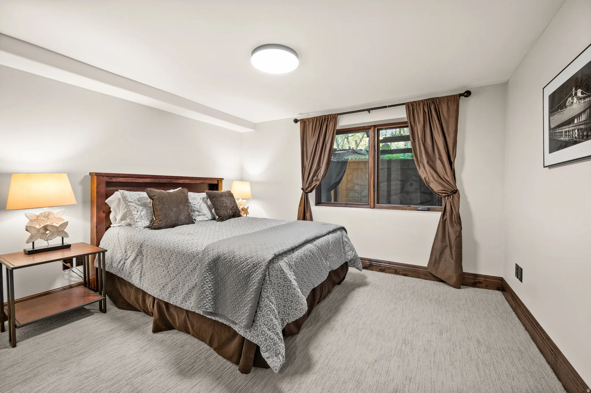 Bedroom with baseboards and light colored carpet