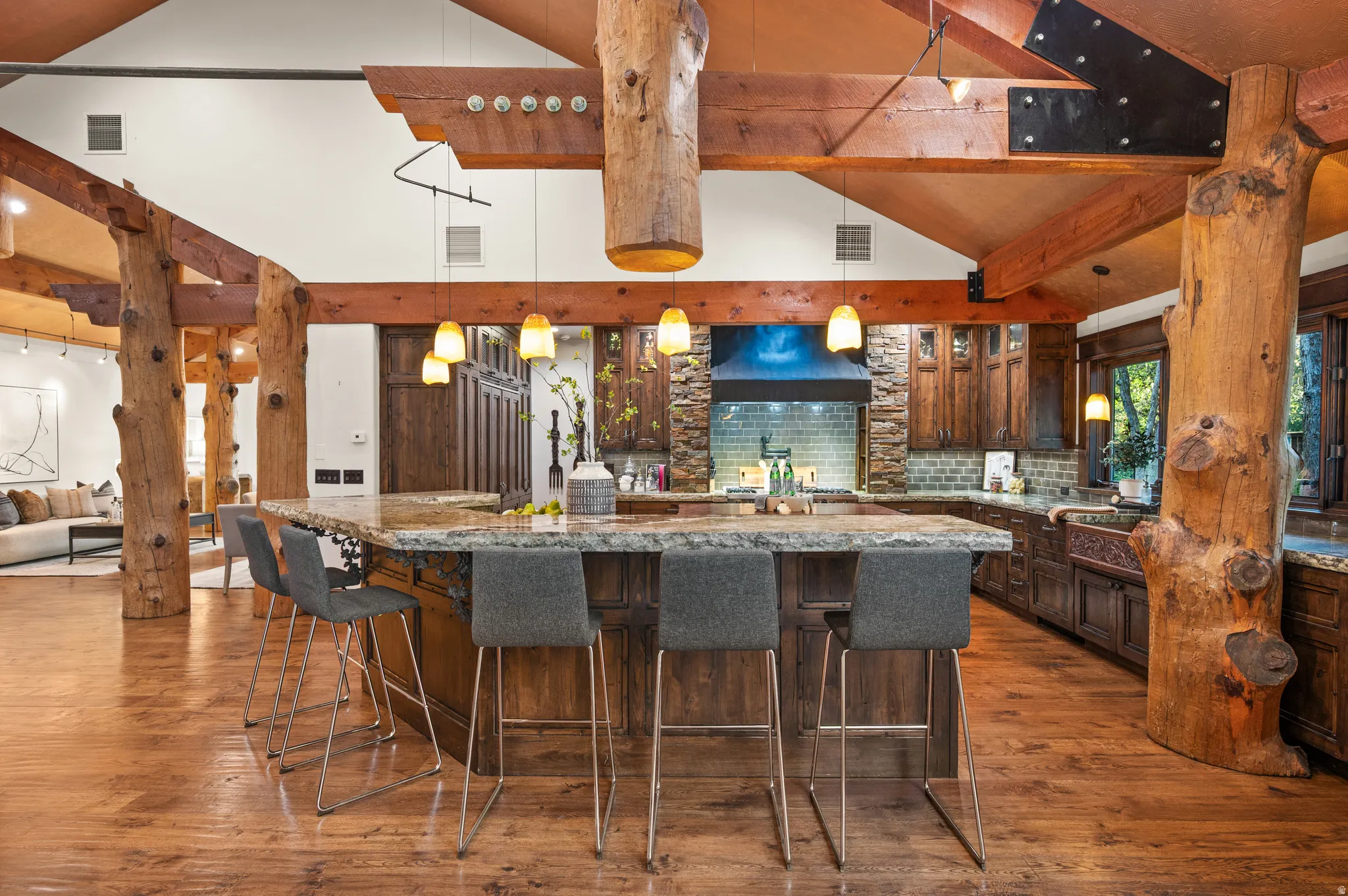 Kitchen featuring light stone countertops, dark wood finish cabinetry, tasteful backsplash, lofted ceiling, and dark wood finished floors