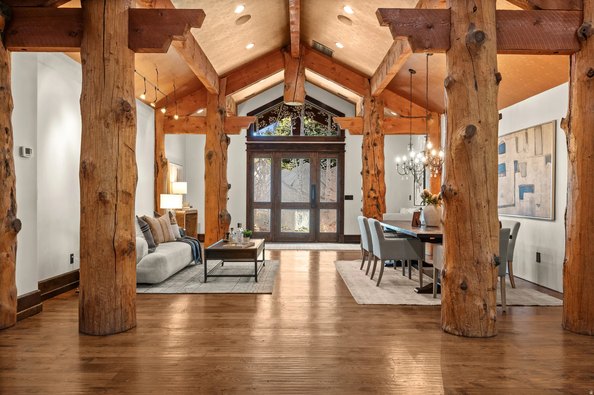 Living room featuring wood-type flooring and hanging lights
