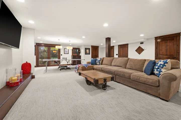 Living room with recessed lighting and light carpet