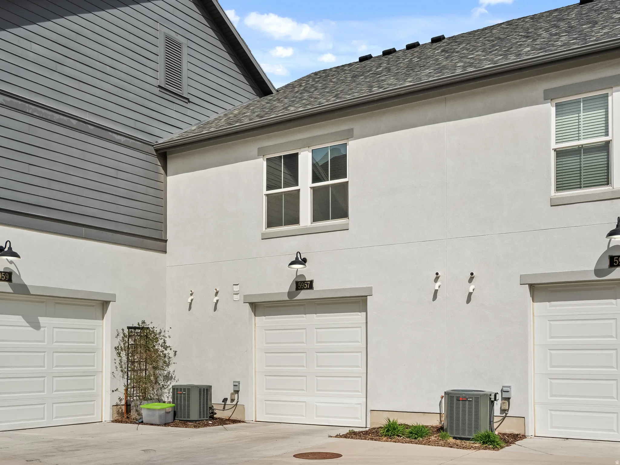 View of side of home with stucco siding and concrete driveway