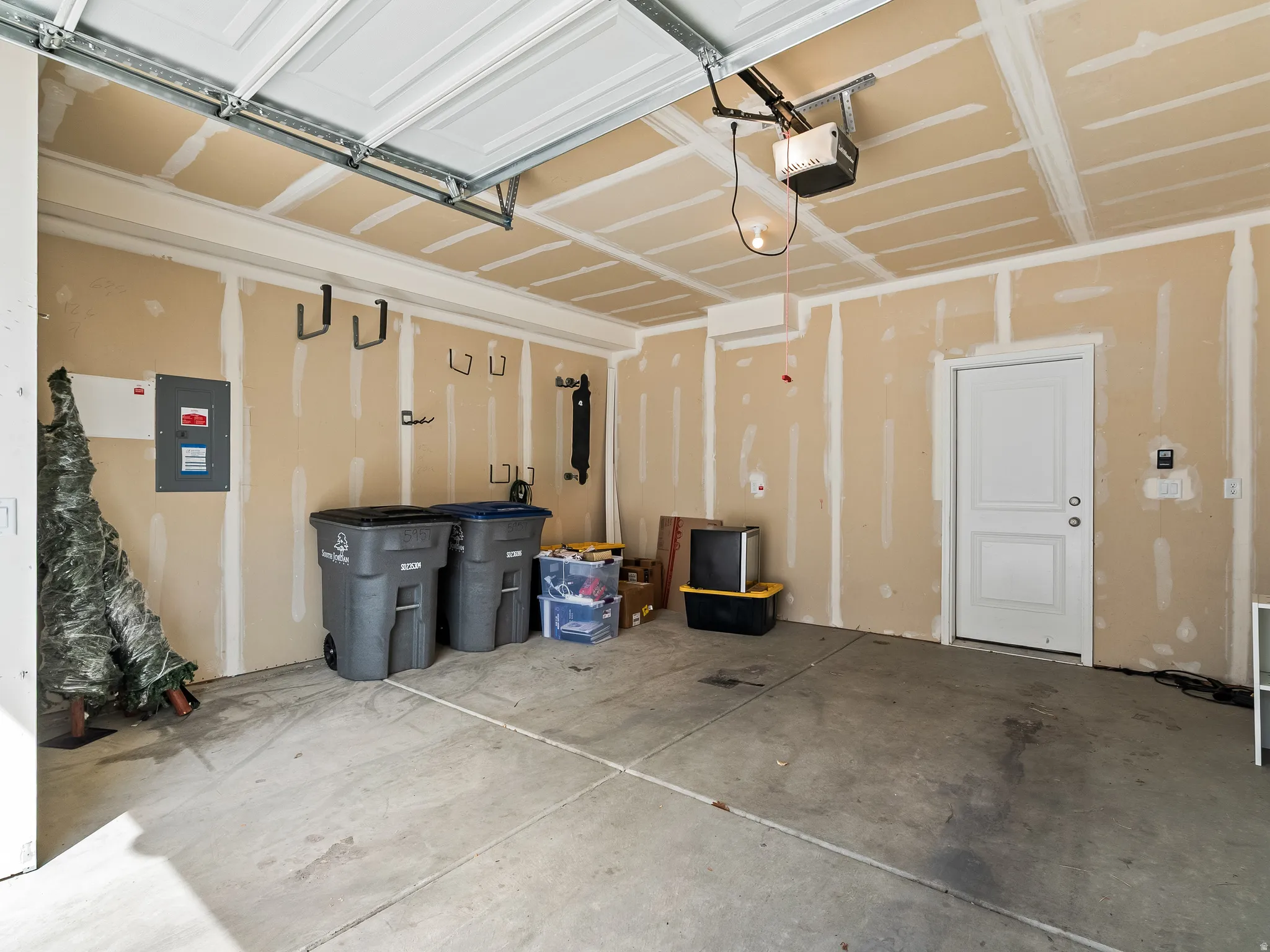Garage with electric panel and a garage door opener