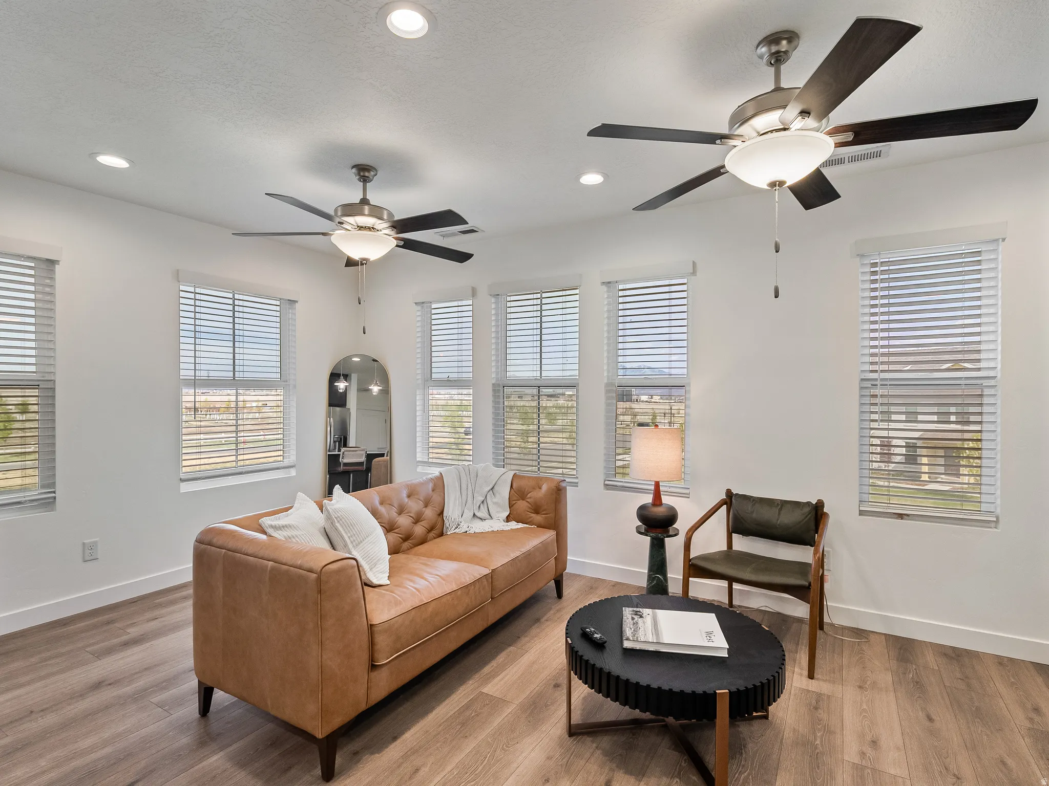 Sitting room featuring recessed lighting, wood finished floors, ceiling fan, and arched walkways