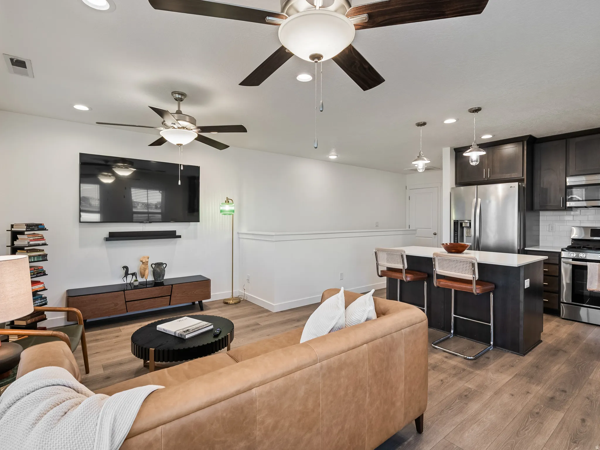 Living area with recessed lighting and dark wood finished floors