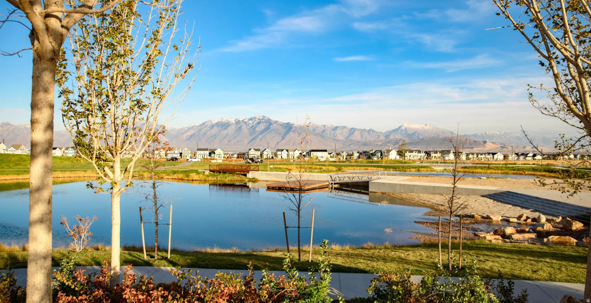Water view with nearby suburban area and a mountainous background
