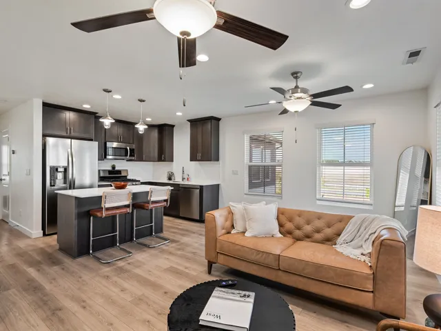 Living room with light wood finished floors, recessed lighting, and ceiling fan