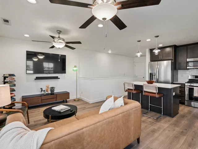 Living area with recessed lighting and dark wood finished floors