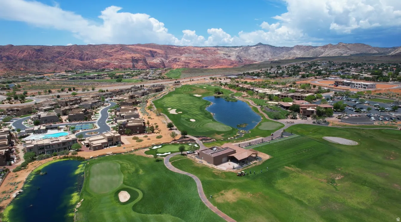 Aerial view of residential area featuring a water and mountain view and a golf course